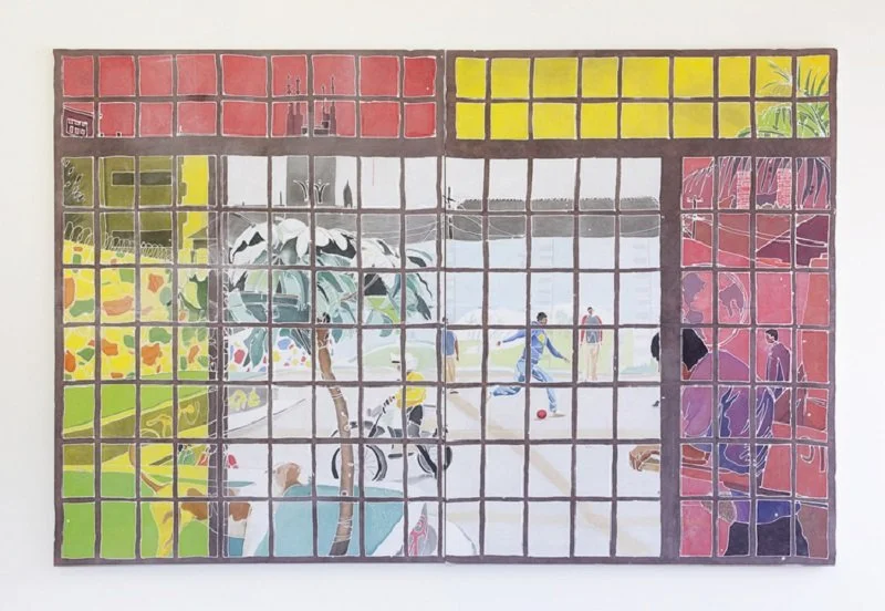 A colorful mosaic mural depicting a park scene with people playing soccer, trees, and a vibrant background divided into geometric sections.