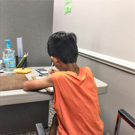 Young boy working at a desk