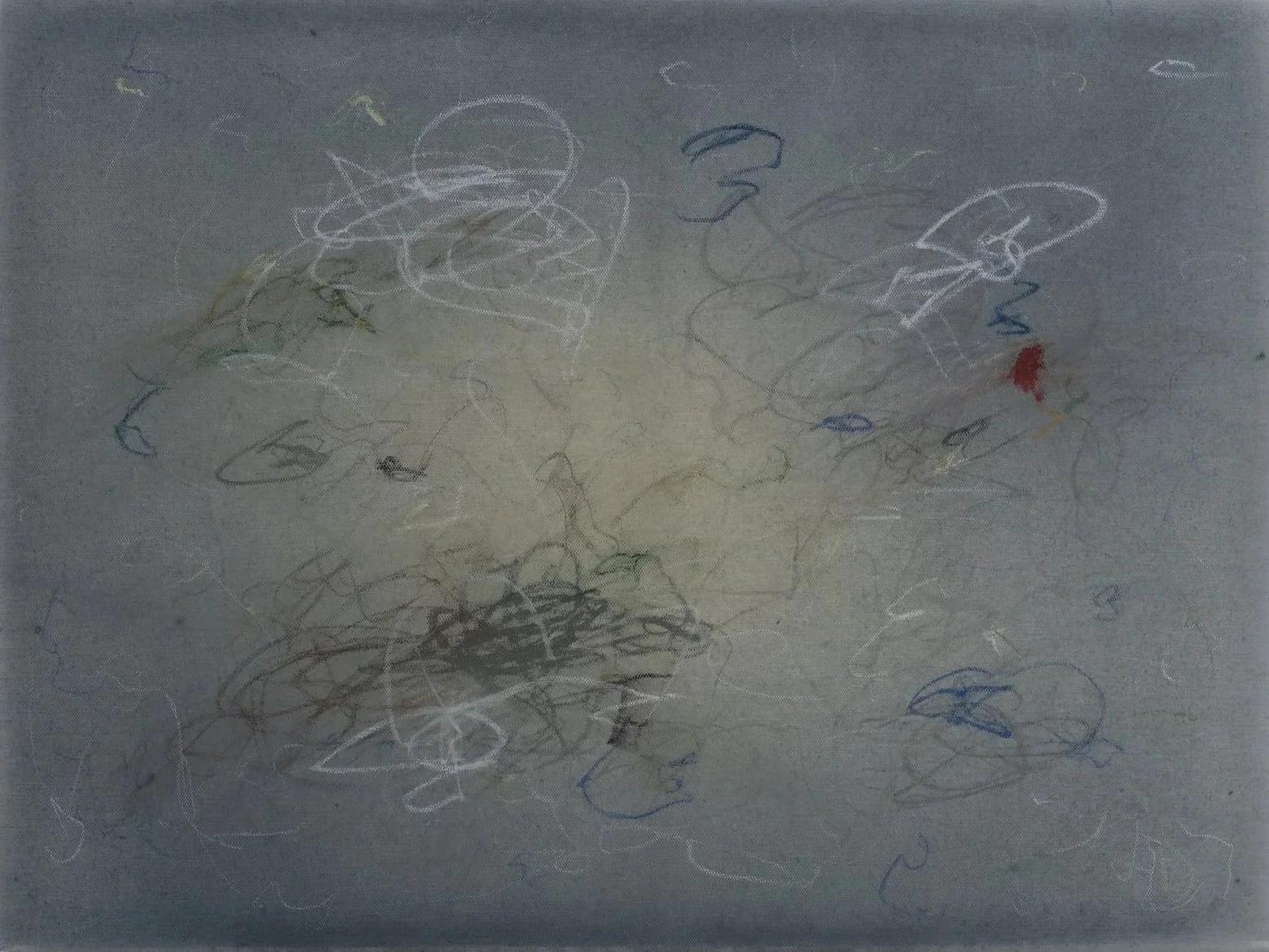 Child's drawing with scribbles and random lines in multiple colors on paper.