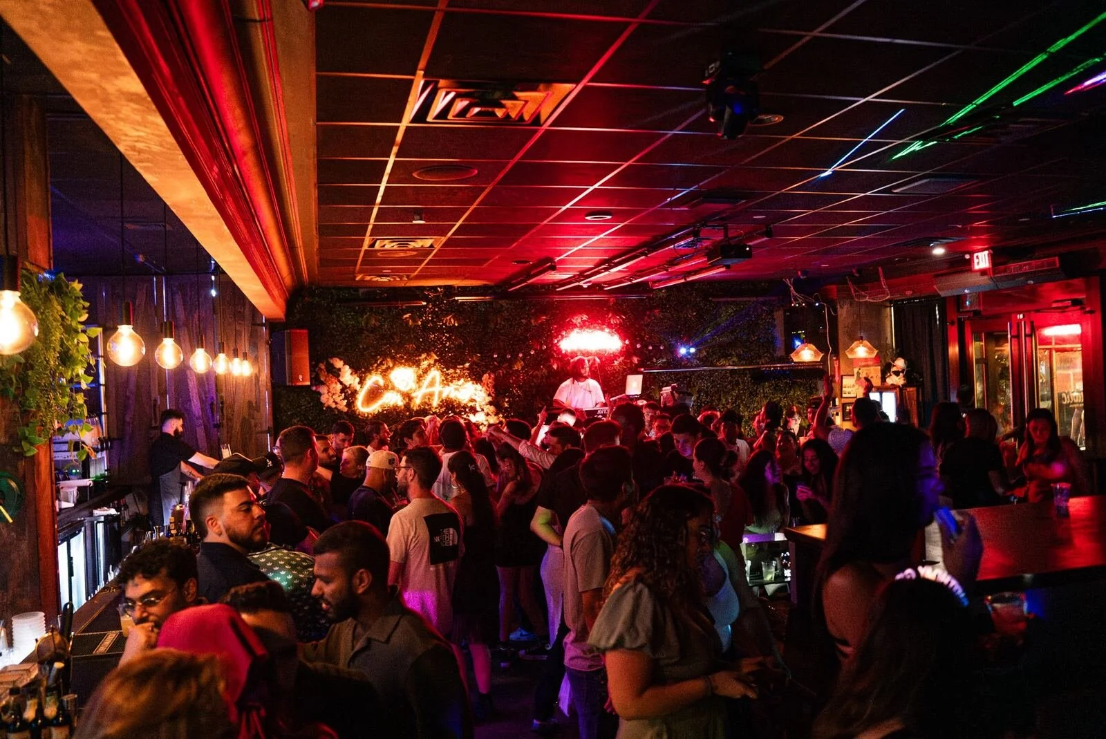 Throwback: wide view of a full room under red and green lights at Republic in Williamsburg, Brooklyn