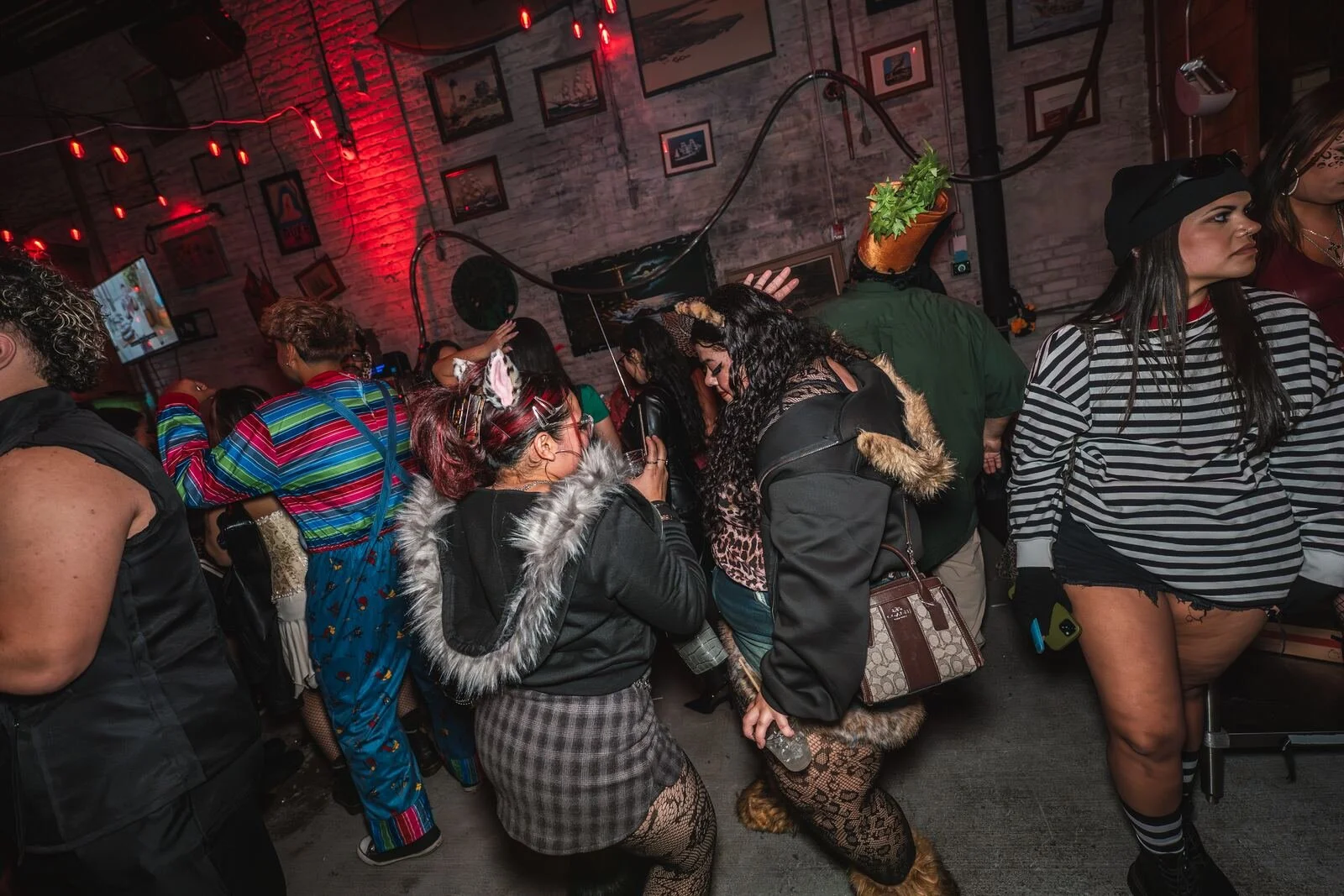 Guests in costumes with furry boots and a striped sweater dancing at Sea Wolf in Bushwick, Brooklyn