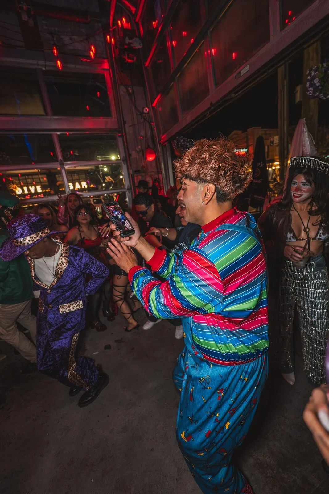 Guest in a striped Chucky-style costume dancing next to a guest in a purple suit at Sea Wolf in Bushwick, Brooklyn