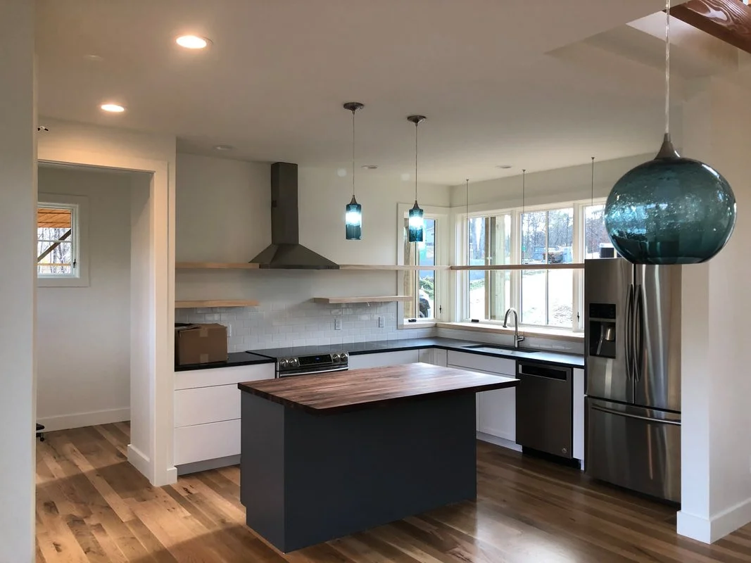 Custom kitchen with walnut butcher block island and radiata pine shelves