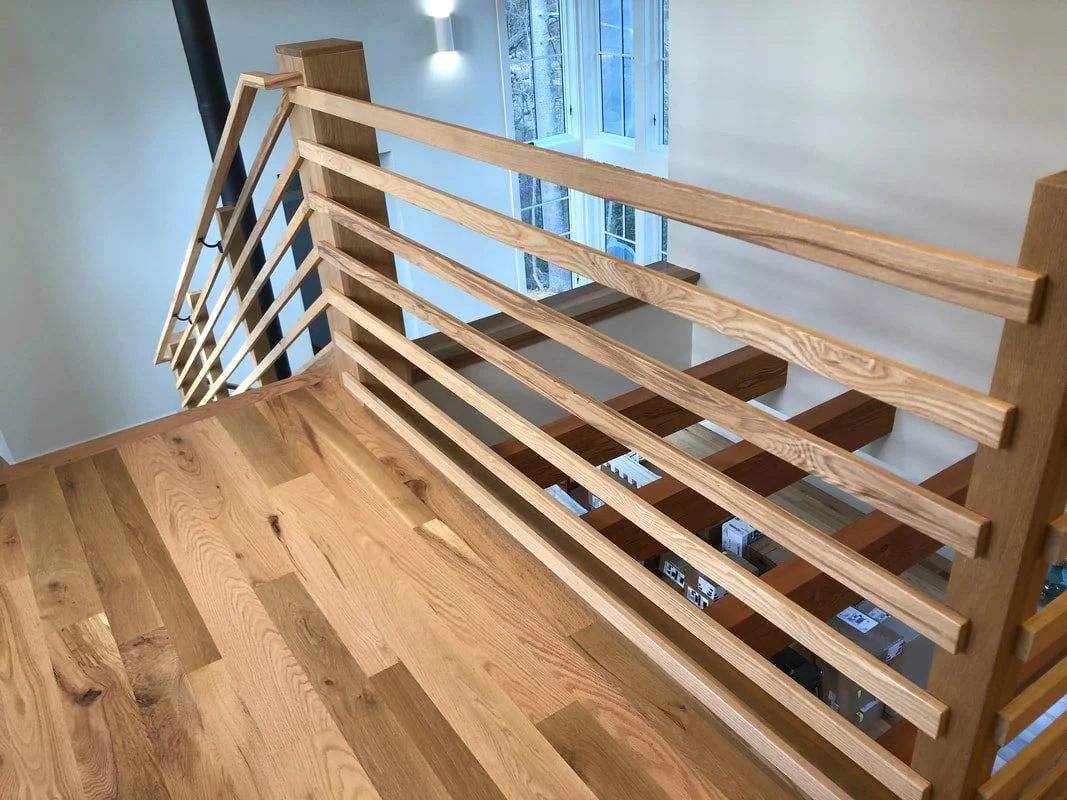White oak staircase railing detail with horizontal balusters