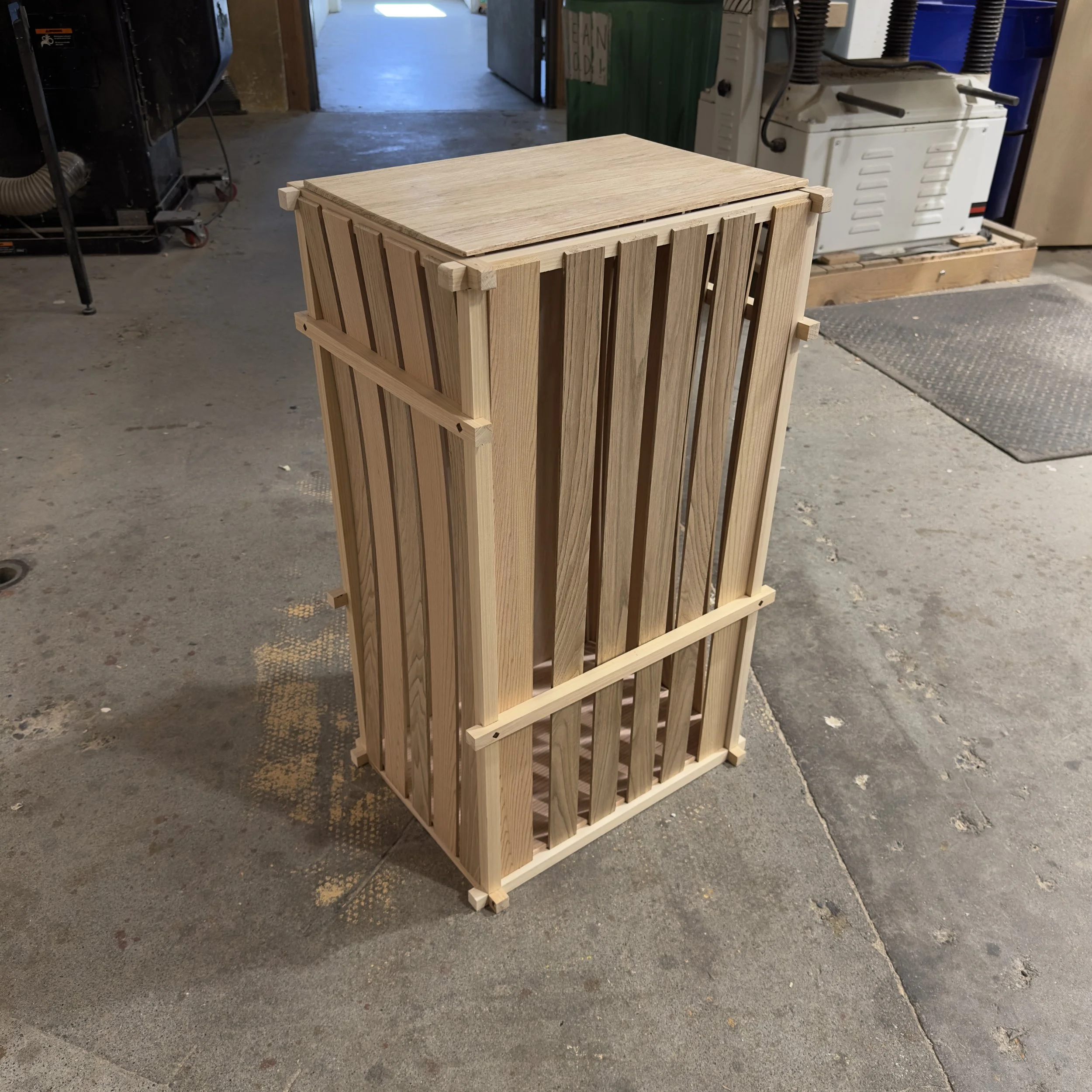 Handcrafted wooden laundry hamper with slatted sides and solid wood joinery