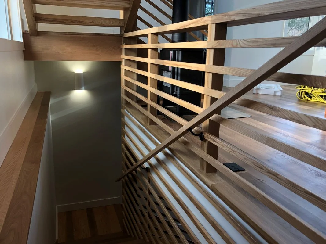 Close-up of custom wood stair railing and joinery detail
