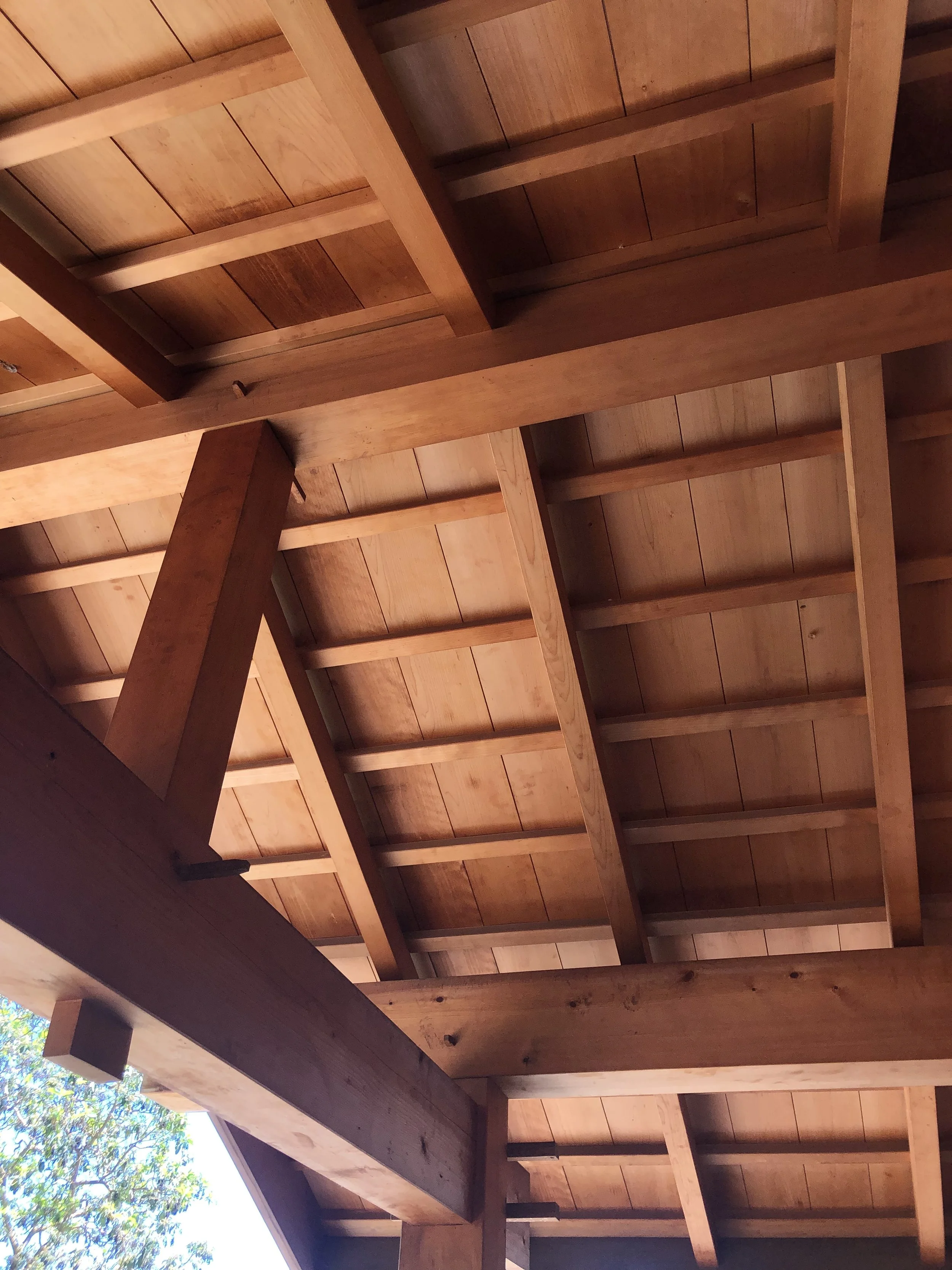Custom timber frame entryway with Port Orford cedar beams and white oak pegs