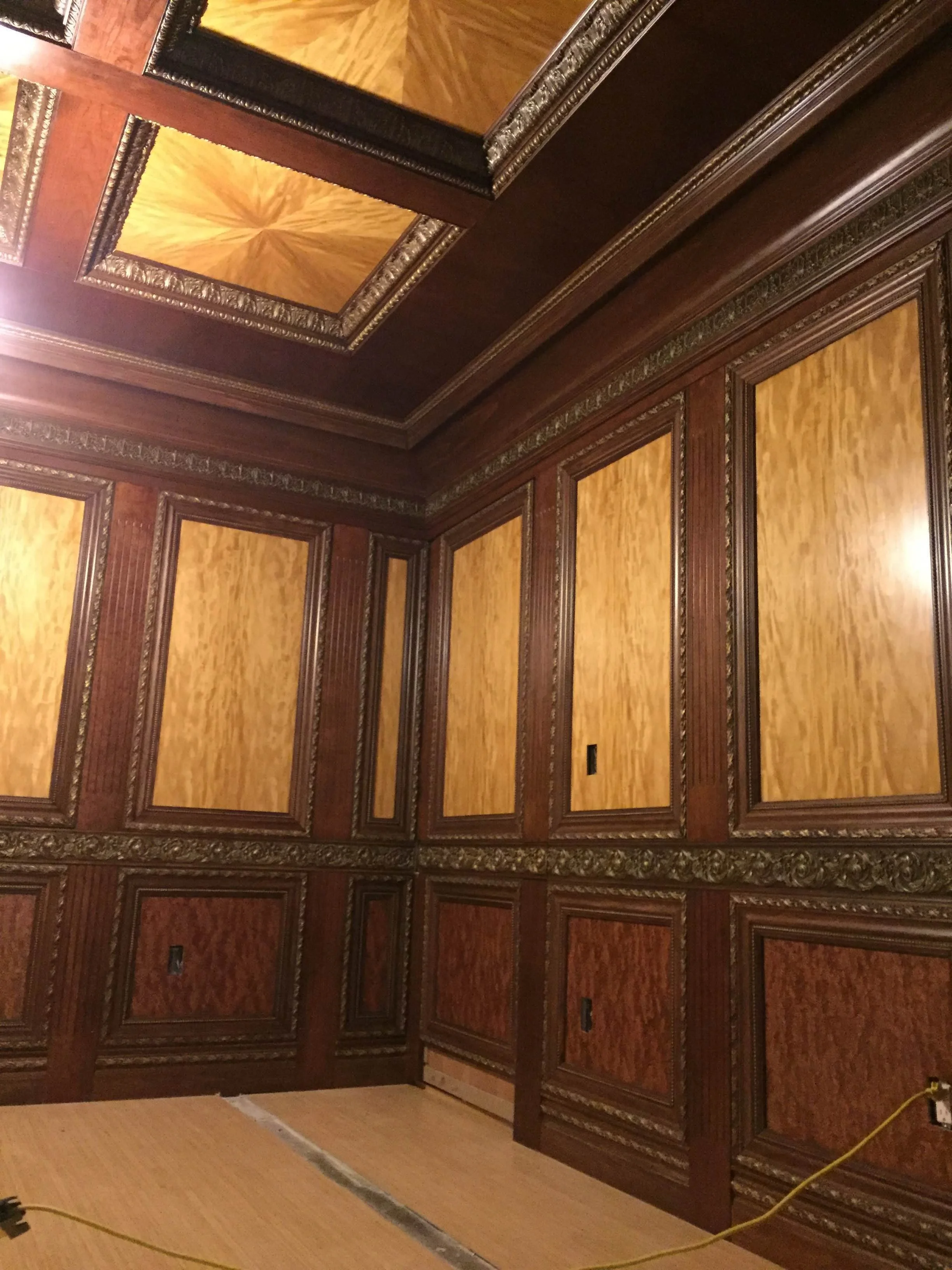Custom wood-paneled office interior with detailed trim and decorative mouldings