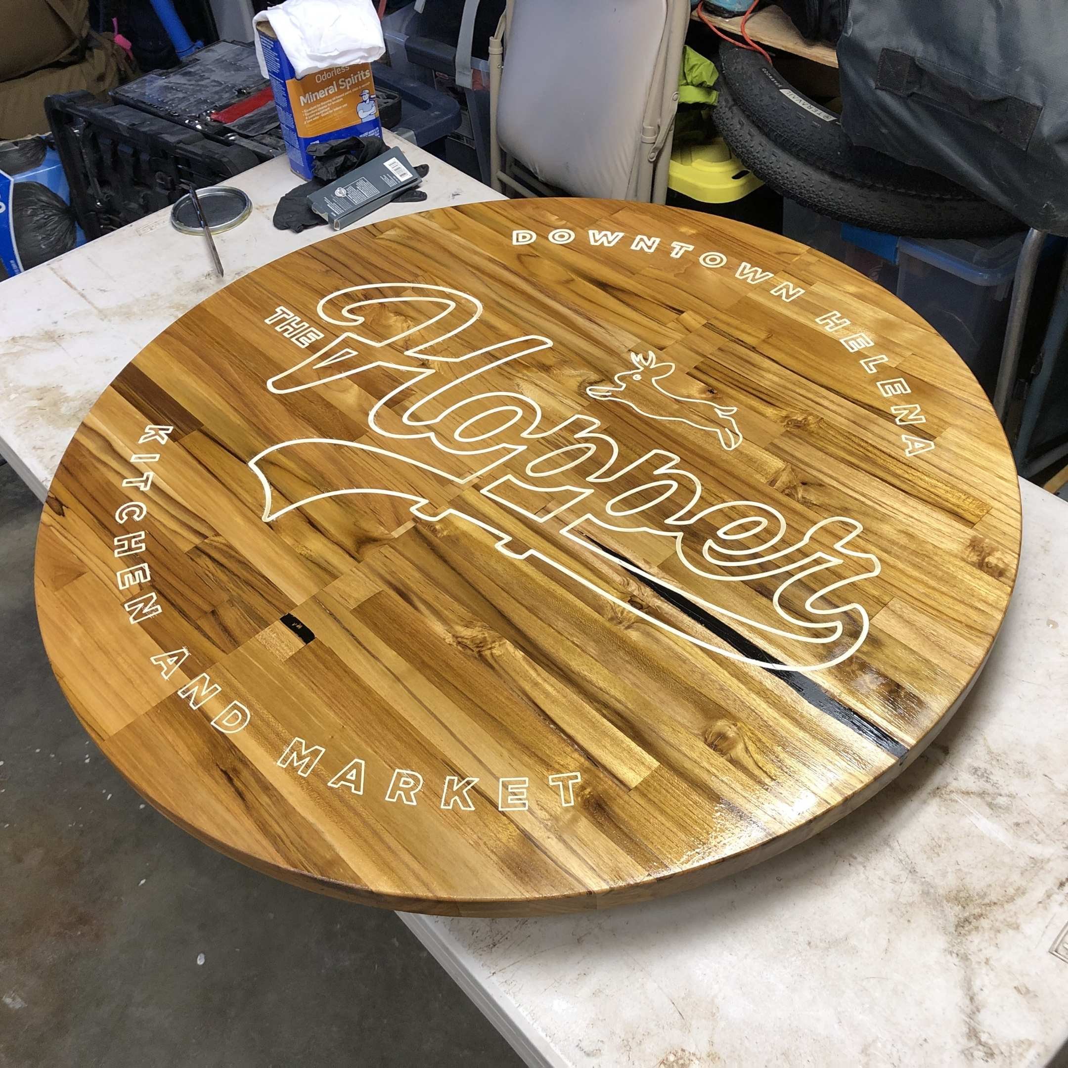 Custom round wood tabletop with engraved logo and inlay detail