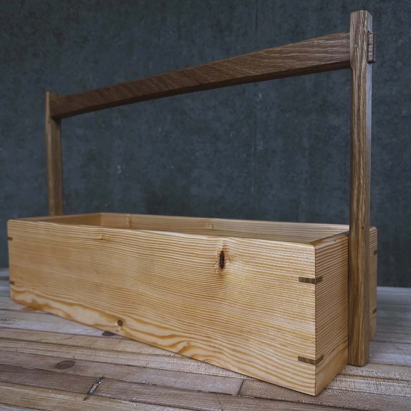 Handcrafted wooden tool caddy with handle and dovetail joinery