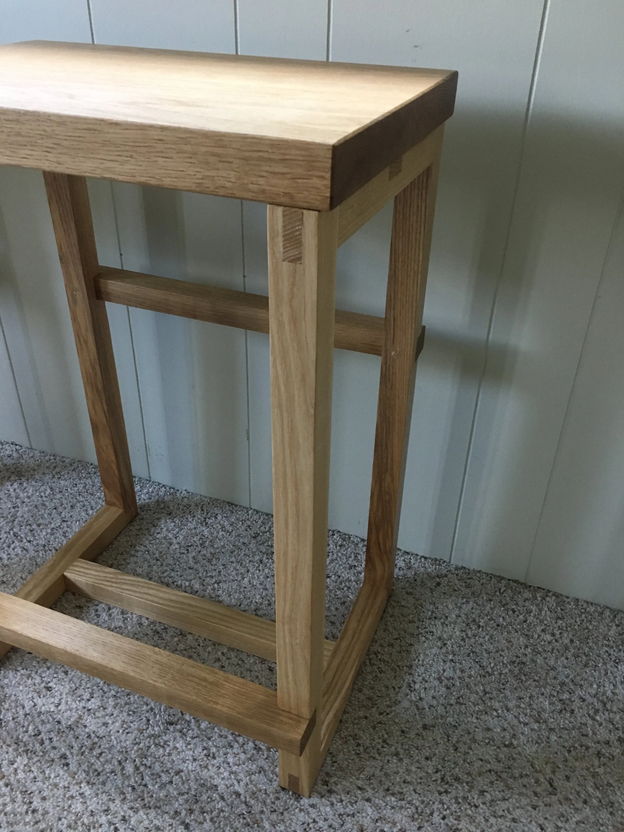 Wood stool with exposed joinery and solid wood seat