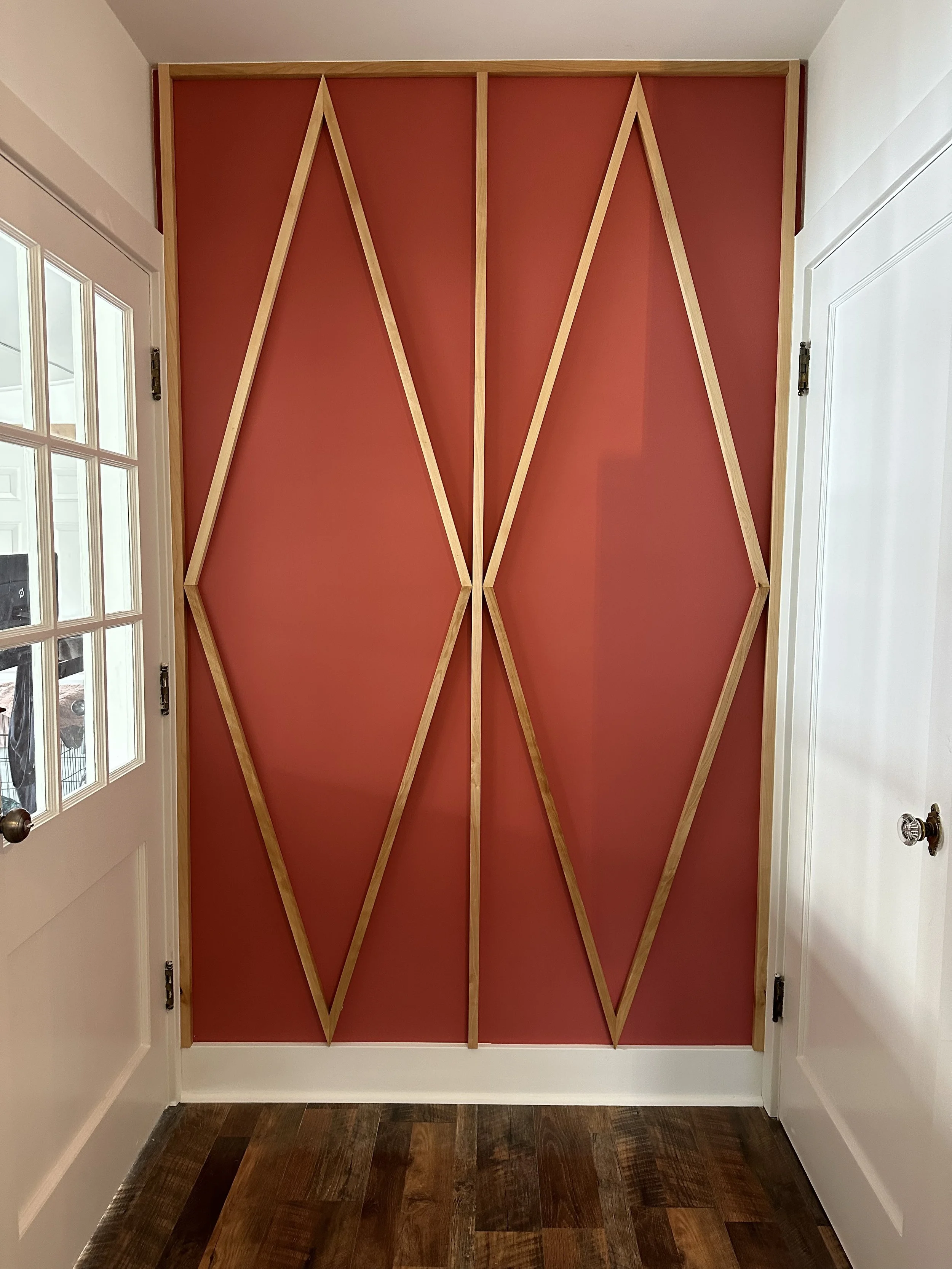 Custom geometric accent wall with painted panels and birch trim detail