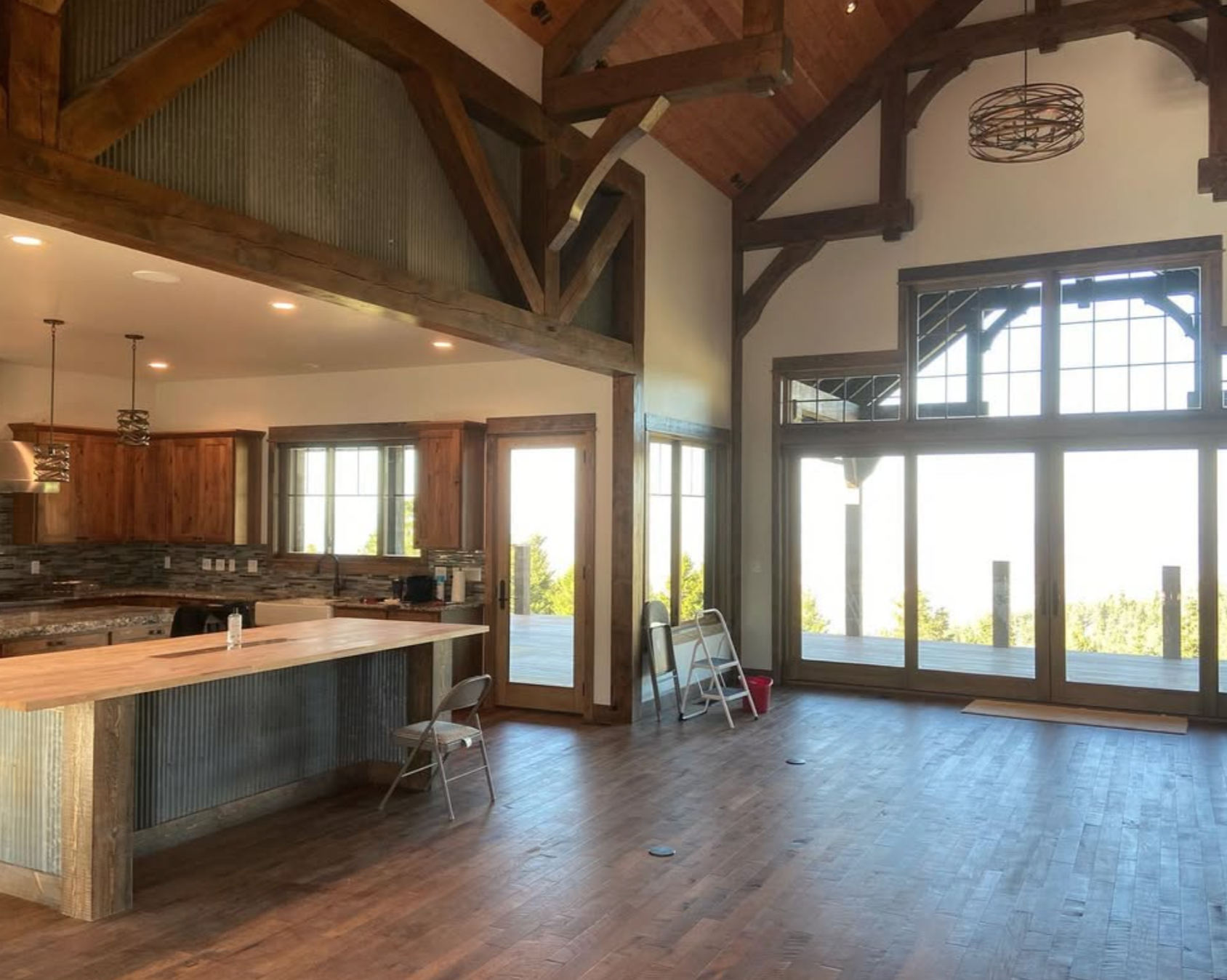 Interior timber frame beams and vaulted ceiling with wood finishes