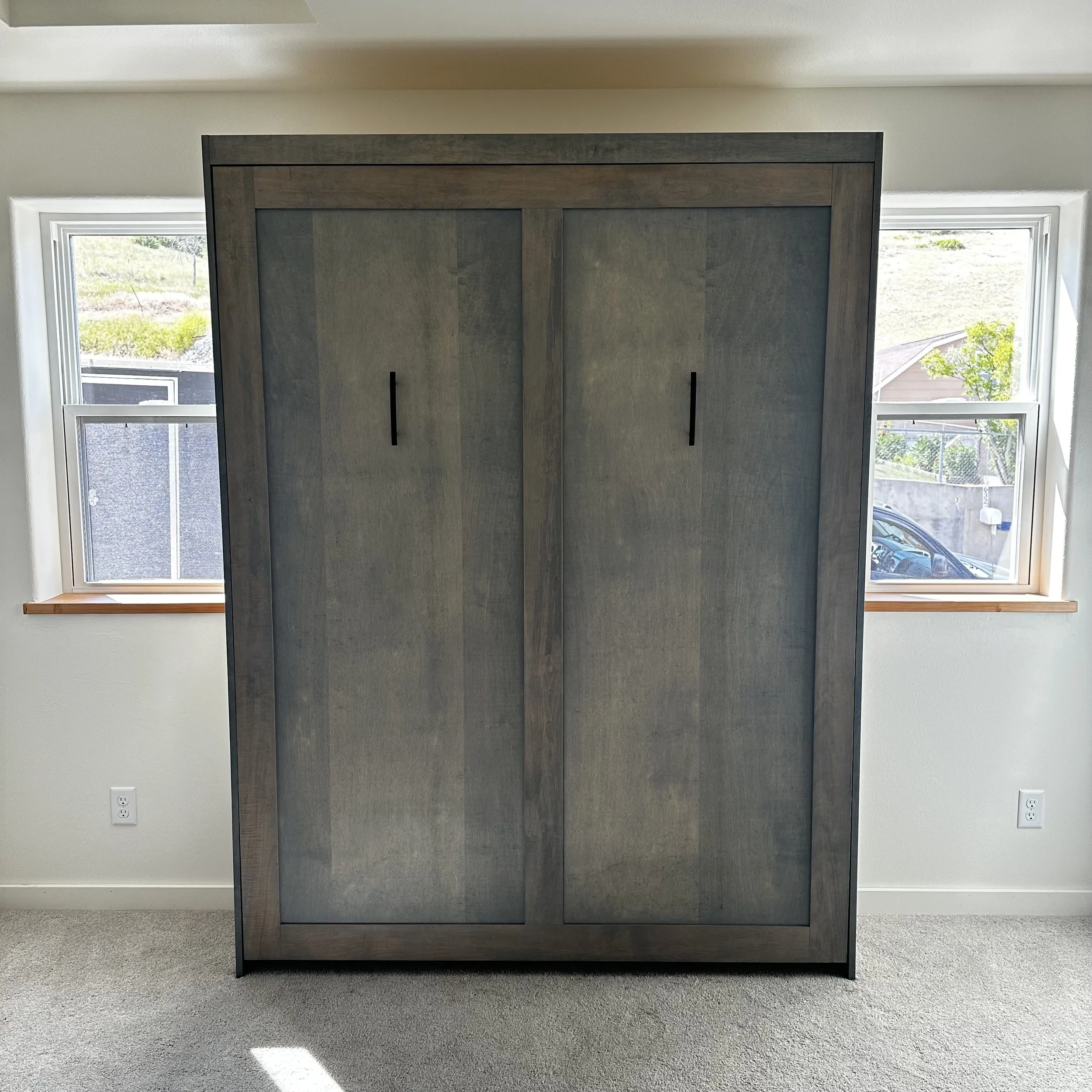 Custom murphy bed cabinet in stained maple with sliding doors