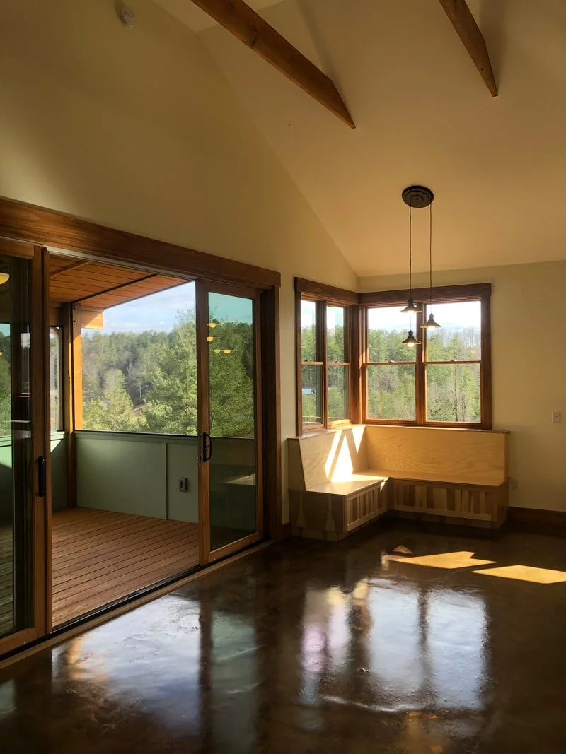 Interior dining area with built-in bench and access to outdoor deck