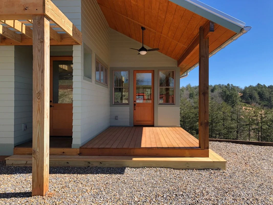 Custom porch with pressure-treated decking and Douglas fir door
