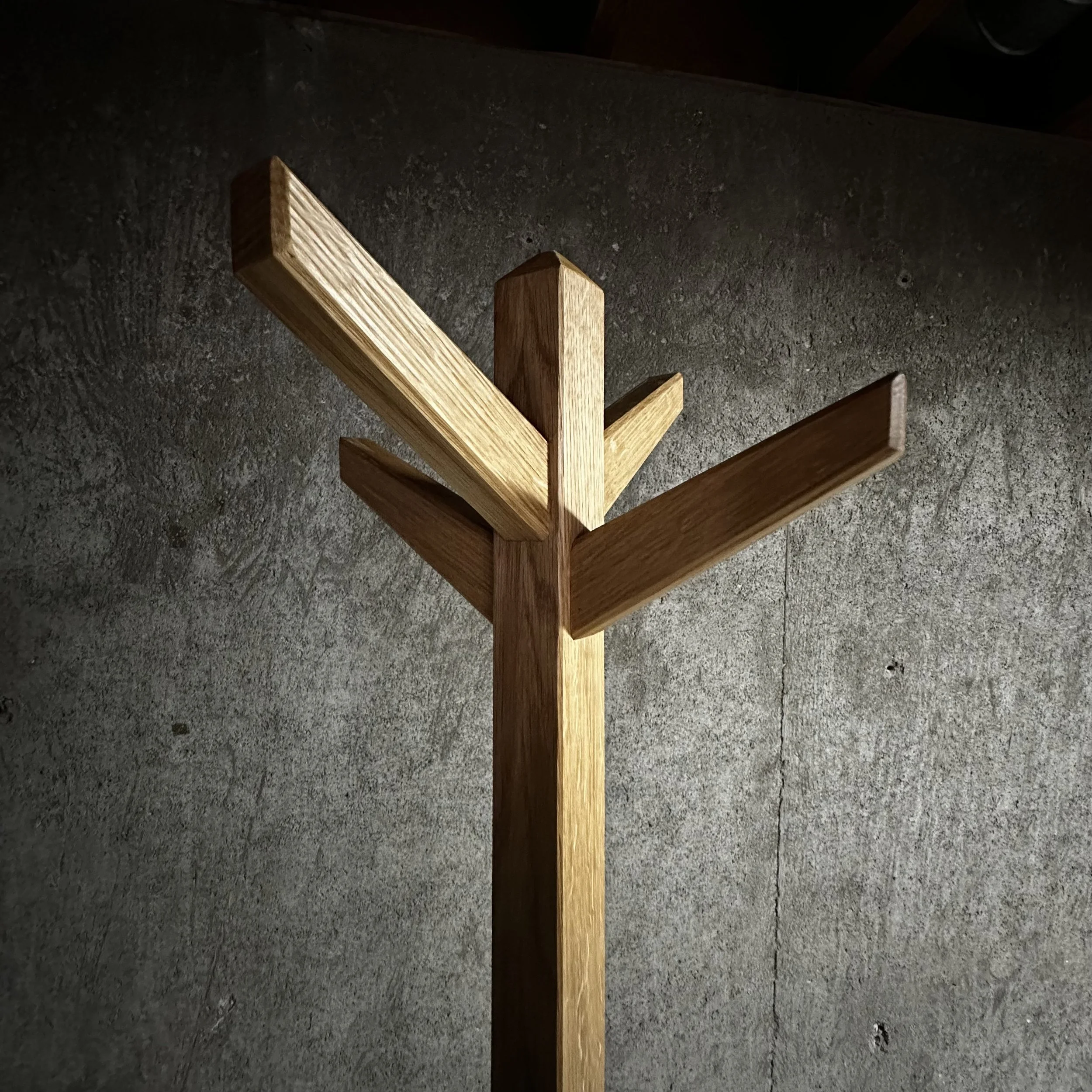 Coat stand detail showing angled wooden arms and joinery