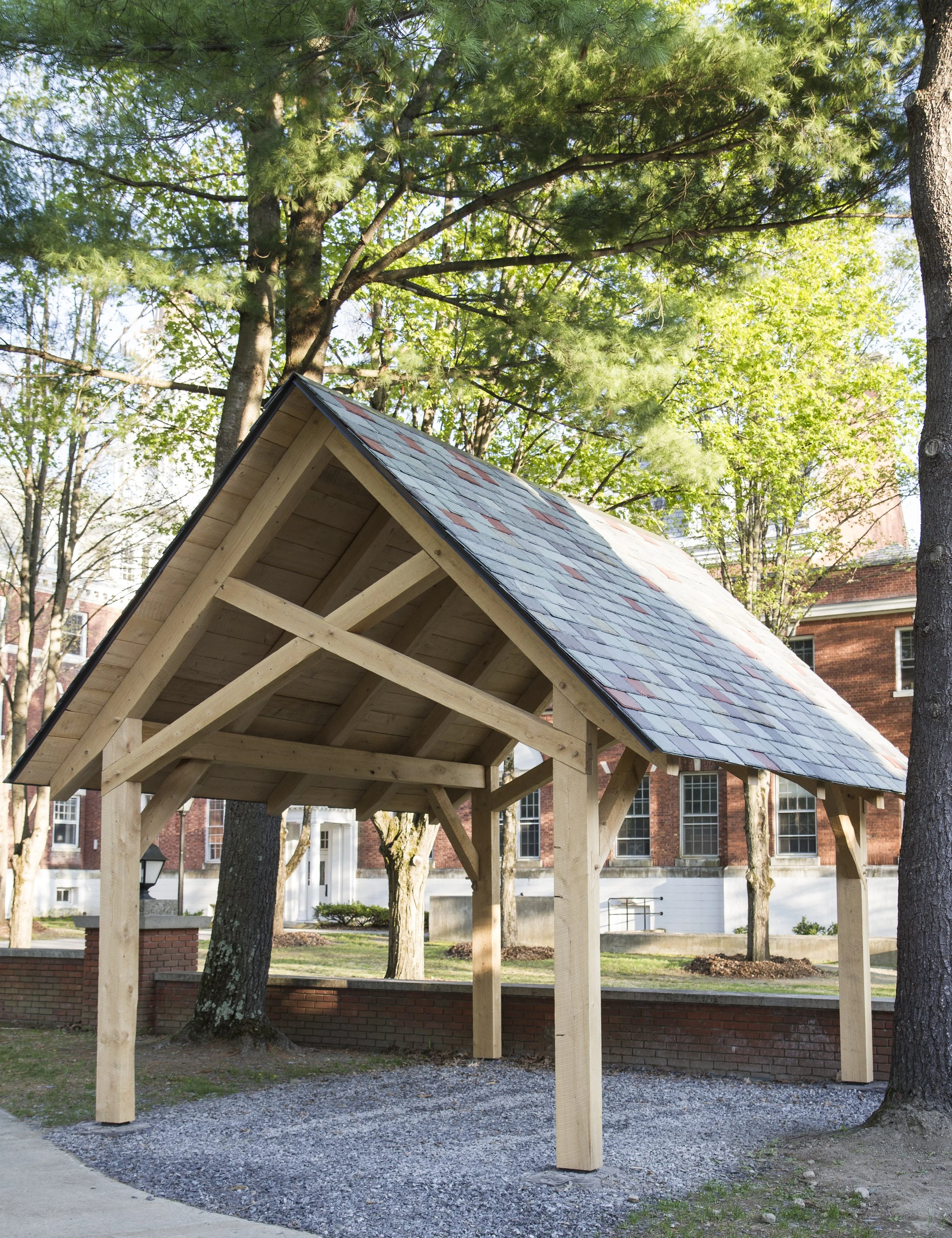 Custom timber frame bike shelter with hemlock beams, white oak pegs, and slate roof