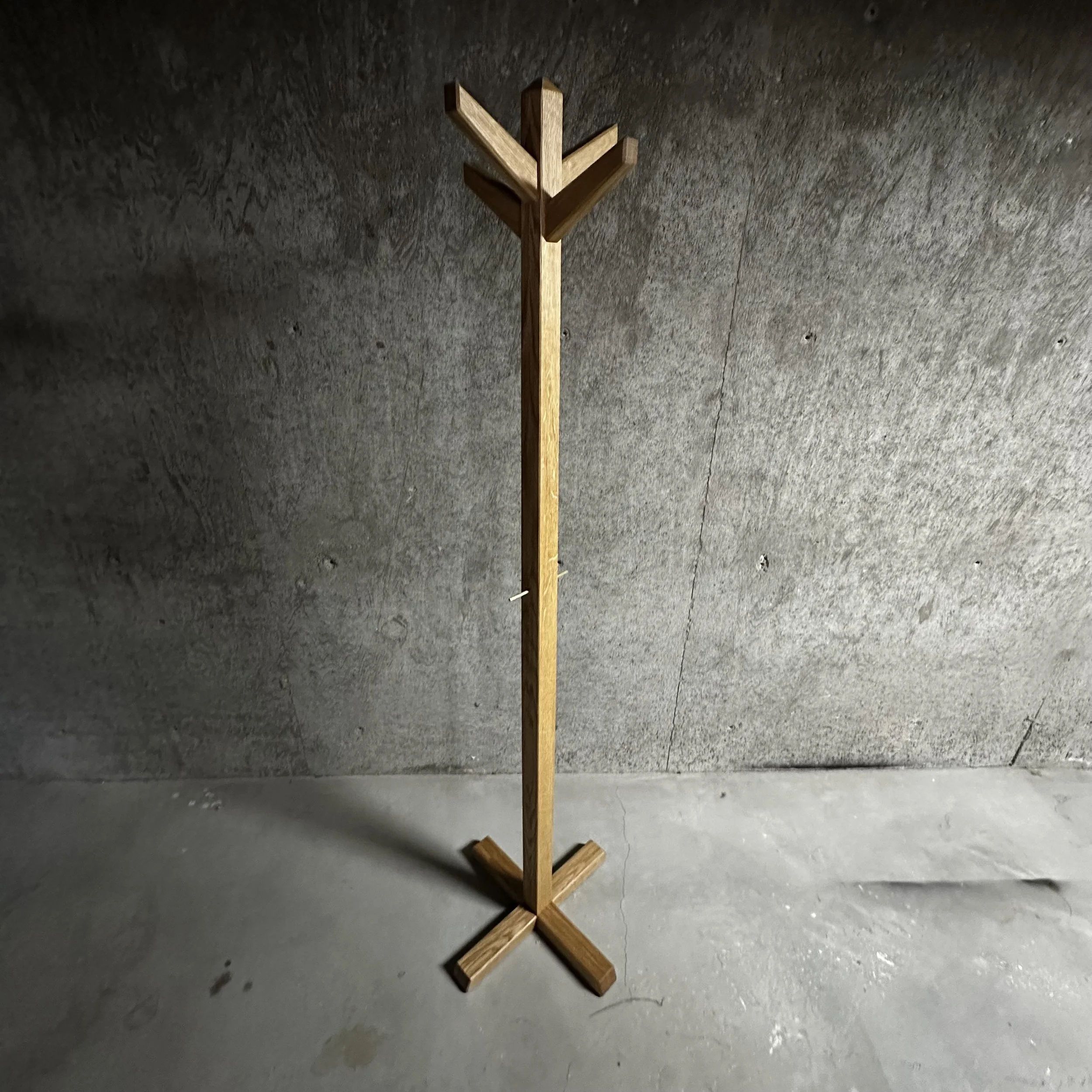 Minimalist coat stand in white oak with brass accents