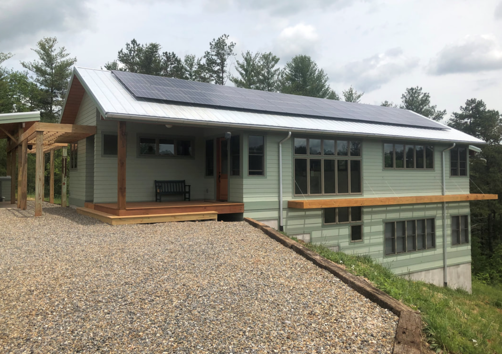 Residential exterior with porch overhang and elevated deck structure
