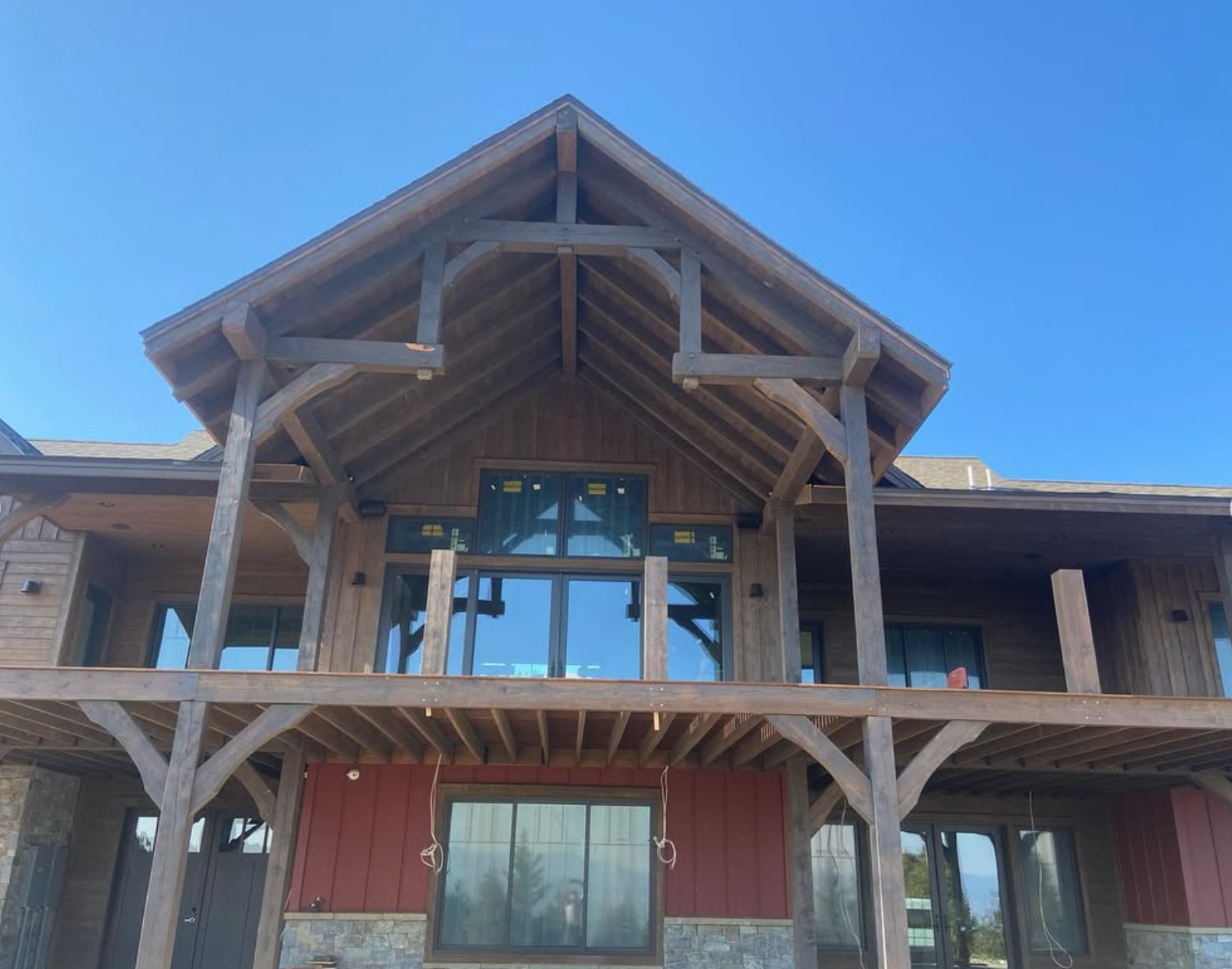 Timber frame home exterior with custom milled Douglas fir beams and deck