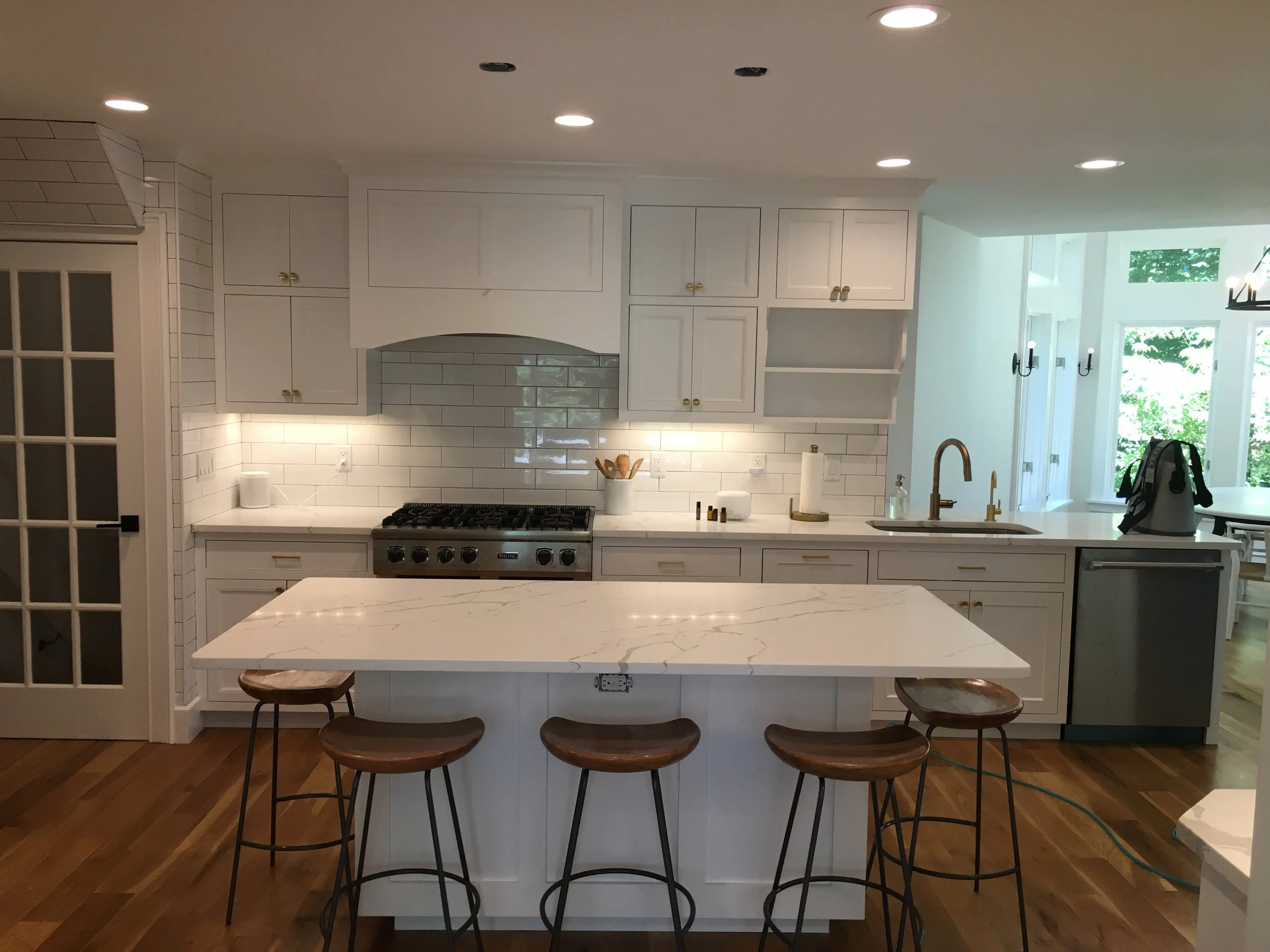 Custom kitchen with painted maple cabinets and quartz island