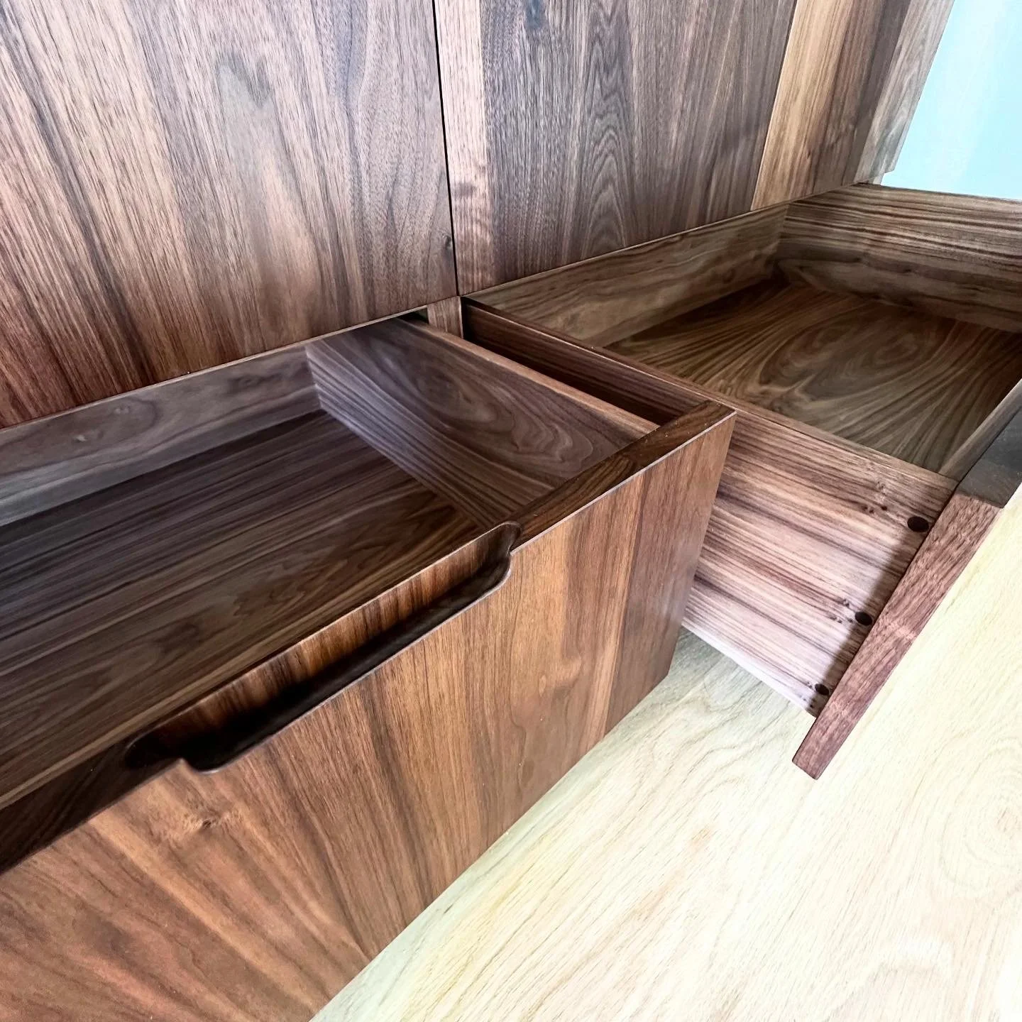 Walnut wardrobe drawer with custom joinery and integrated handle