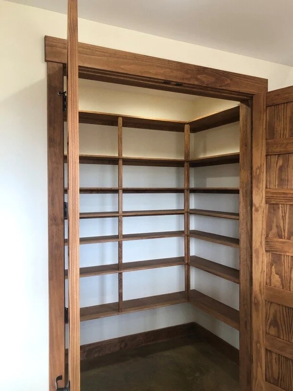 Custom built-in pantry shelving made from stained radiata pine