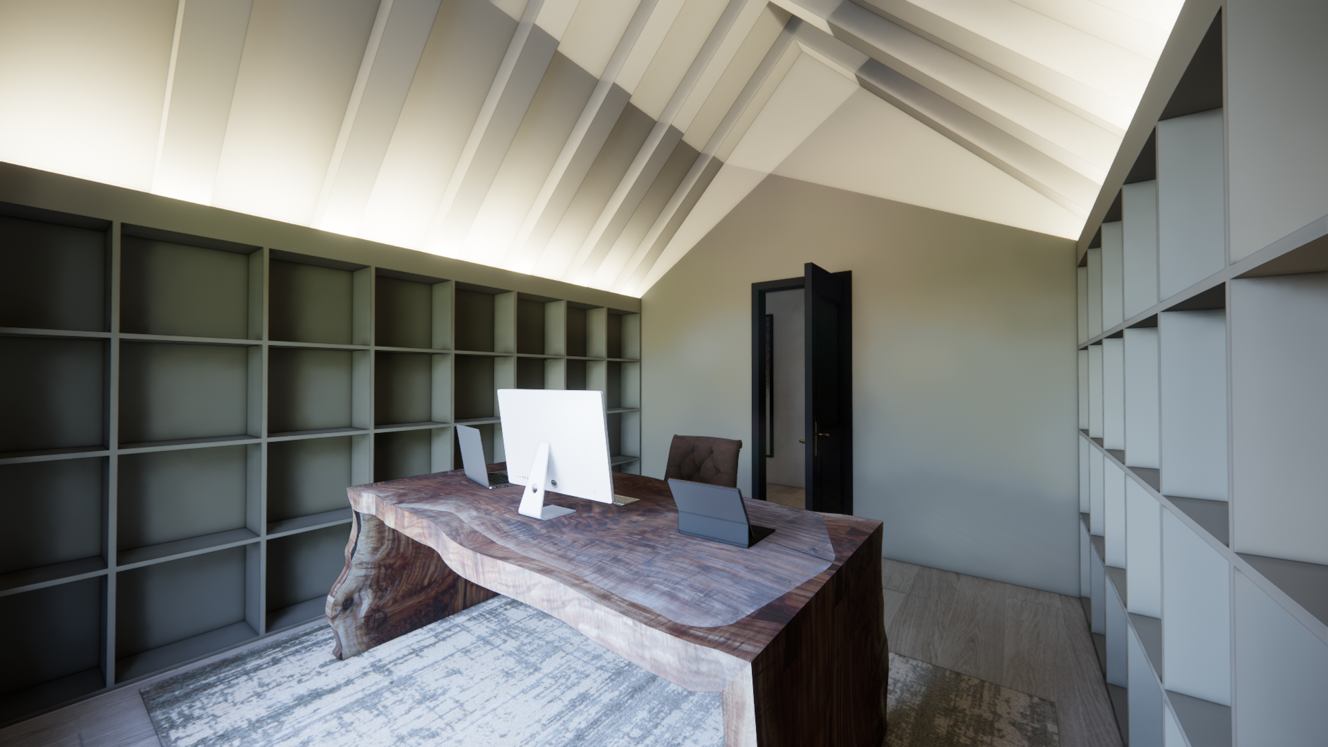 A modern attic office with a sloped ceiling, white shelving on both walls, a wooden desk with a computer, and a brown office chair.