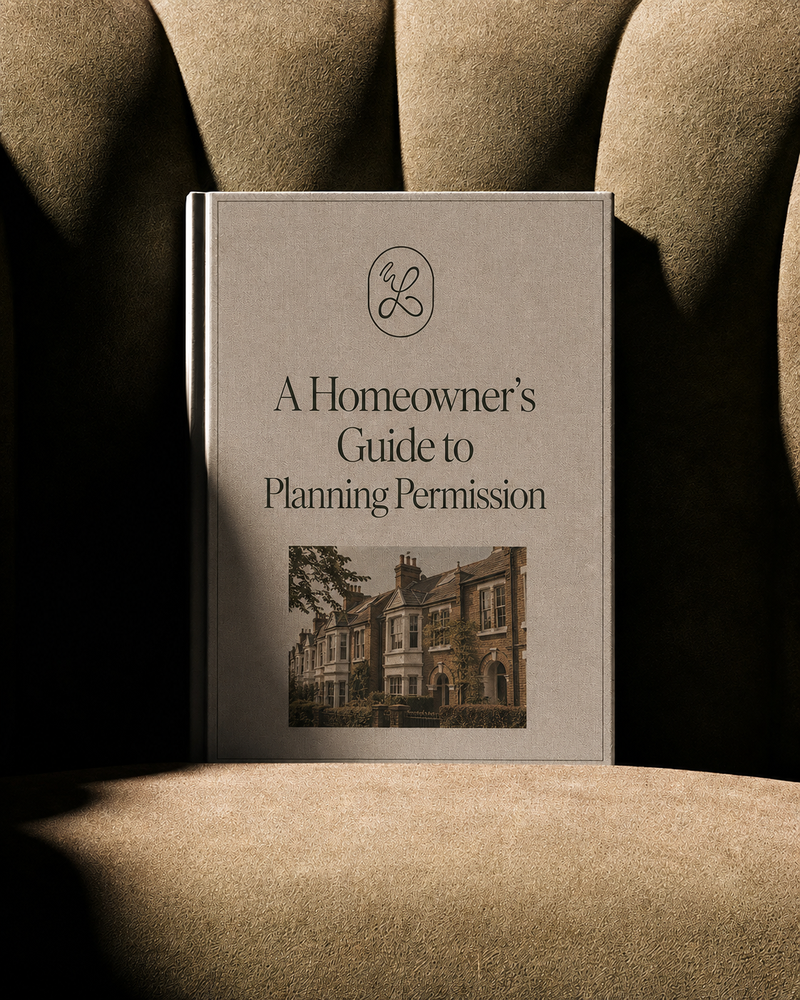 A book titled "A Homeowner's Guide to Planning Permission" resting on fabric with shadows cast over it.