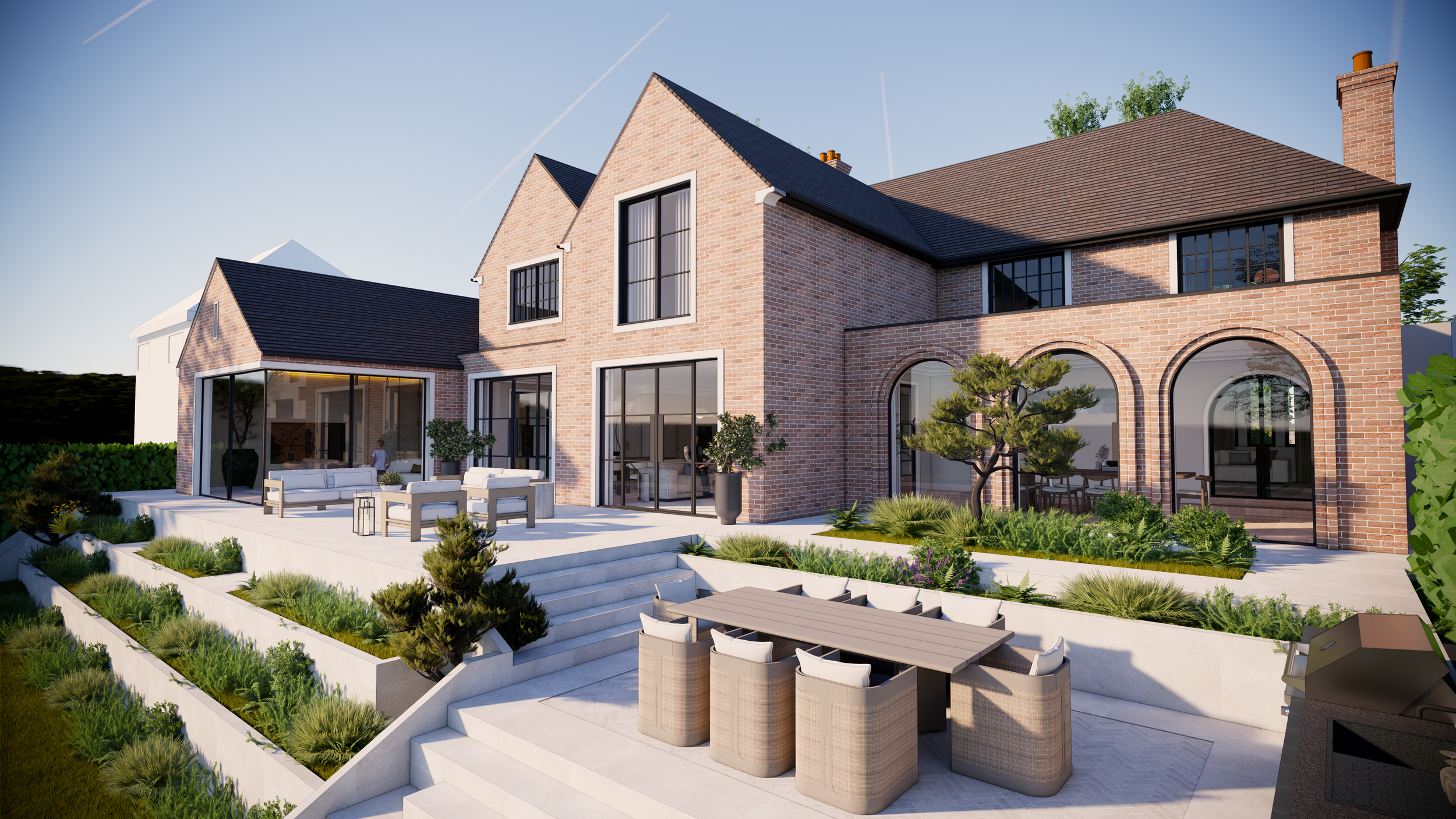 Modern brick house with an outdoor patio featuring seating, dining area, and landscaped garden, under a clear sky.