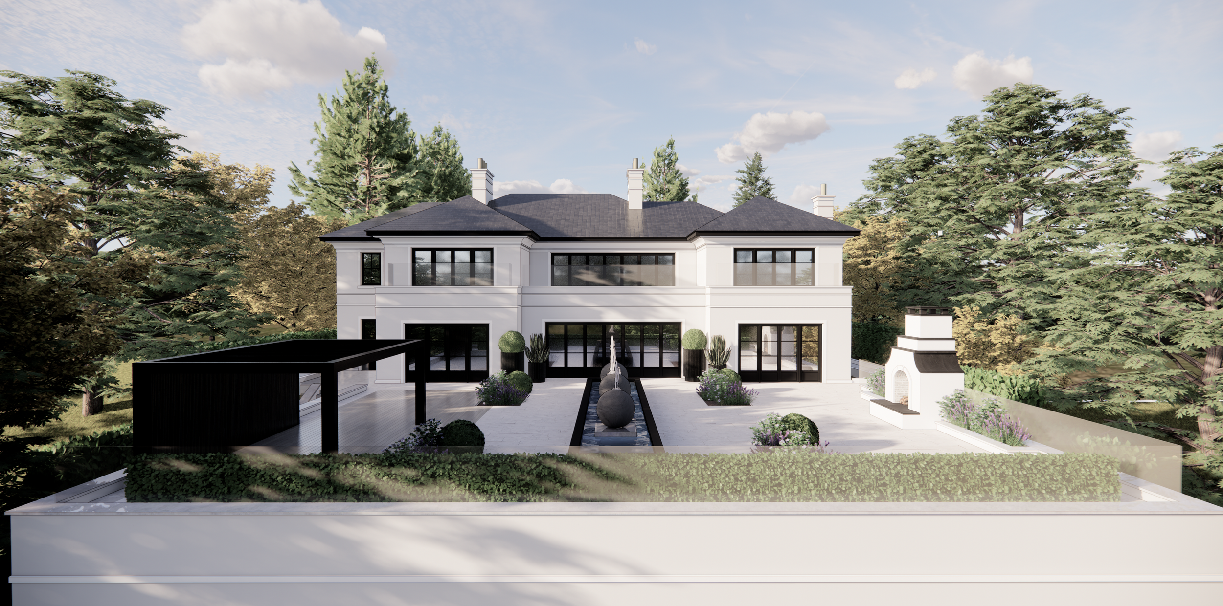 Modern white two-story house with black window frames, surrounded by tall trees, with a landscaped yard featuring a fountain, potted plants, and an outdoor fireplace, under partly cloudy sky.