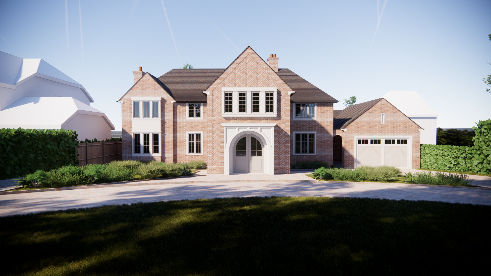 Front view of a large brick house with a gabled roof, multiple windows, a central arched doorway, and an attached garage, surrounded by green bushes and trees under a clear blue sky.