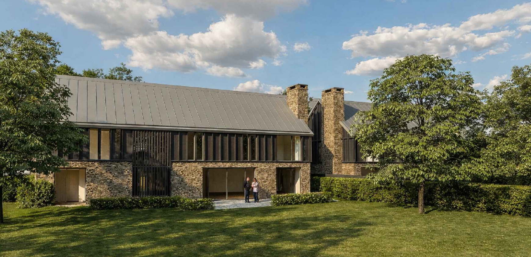 Modern house with stone and black accents, a metal roof, surrounded by green trees and a well-maintained lawn on a sunny day with a partly cloudy sky.