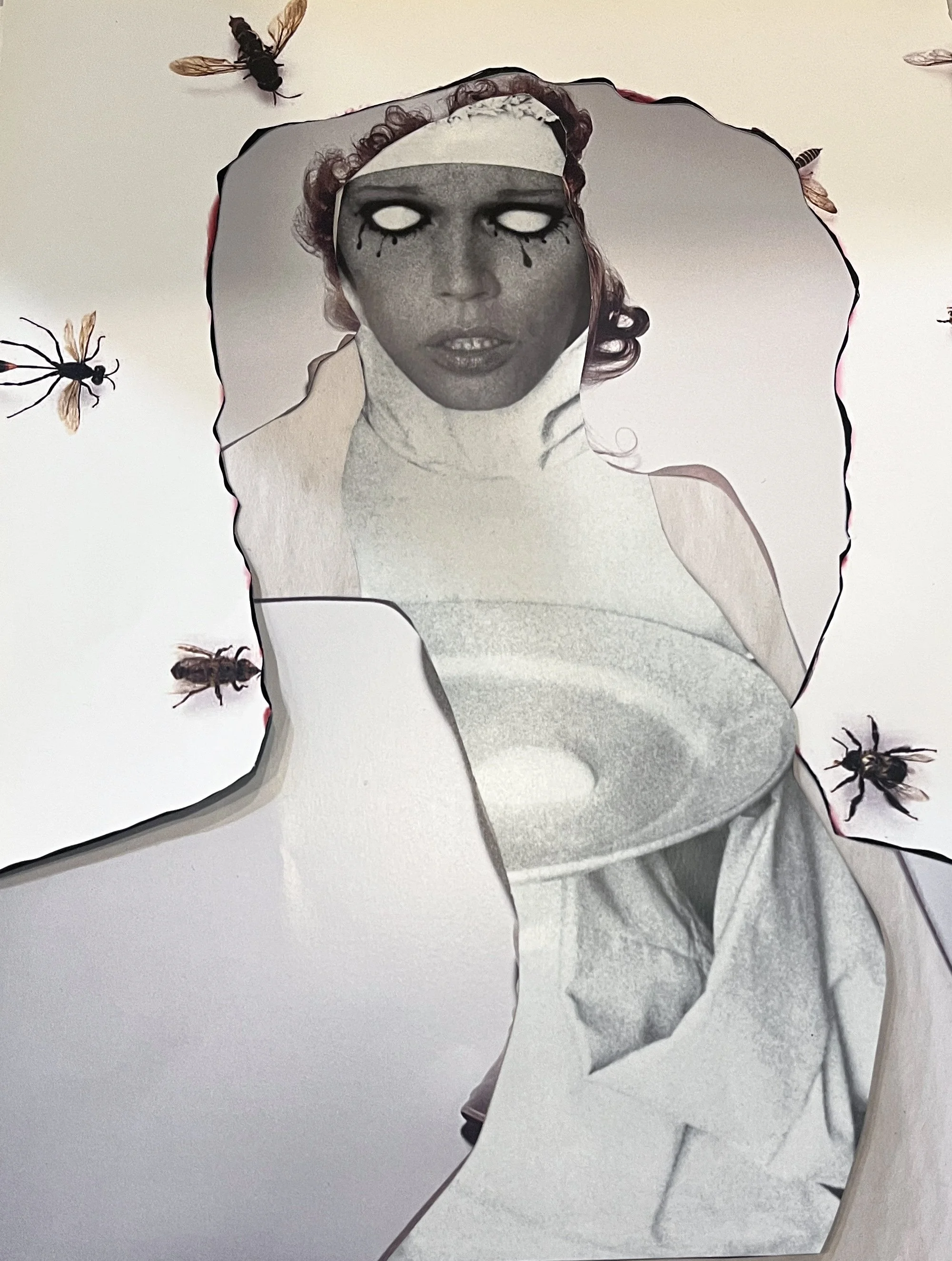 A black and white photograph of a woman's face with glowing eyes and black tears, surrounded by cut-out paper shapes with images of bees on a white background.