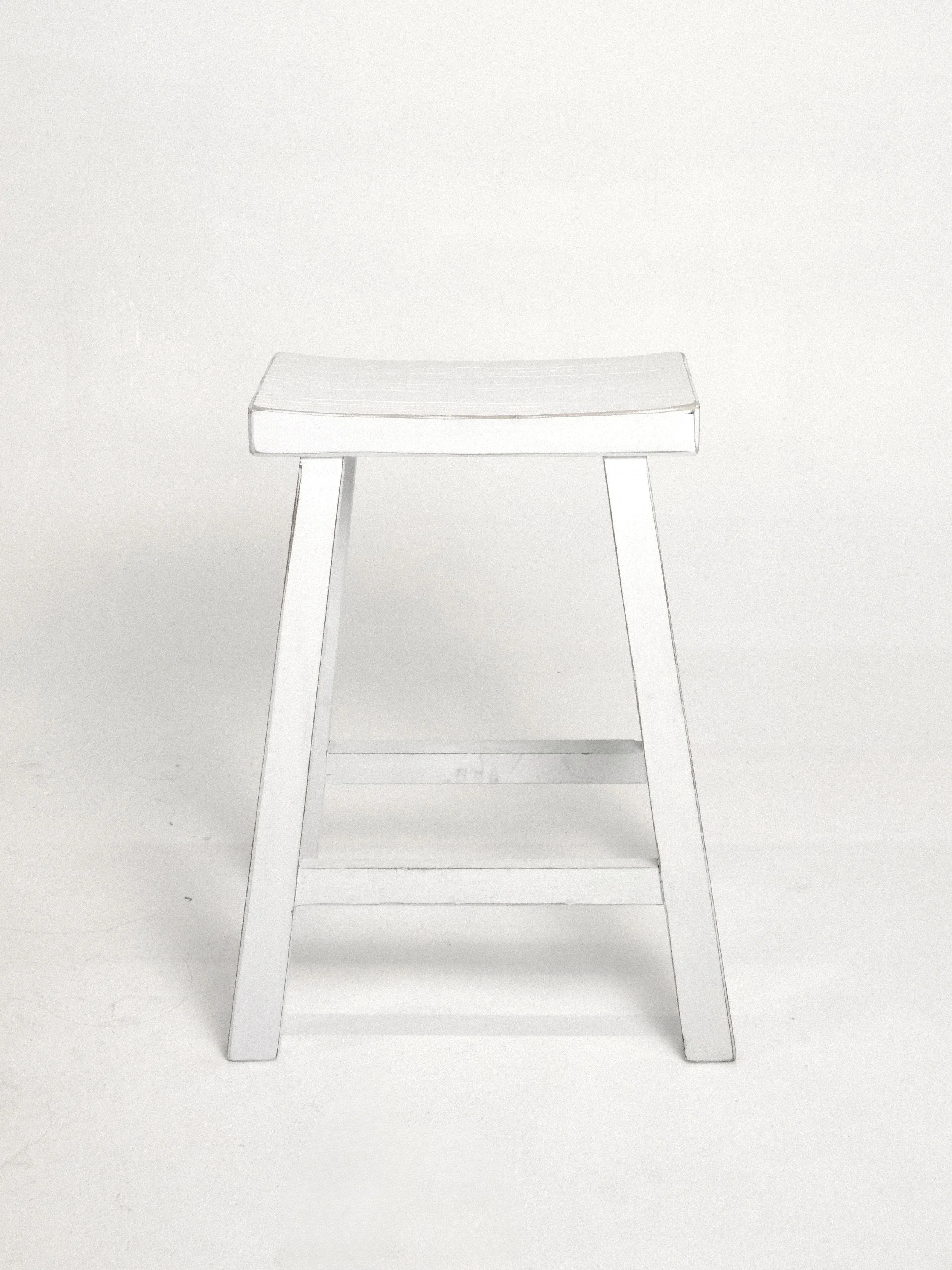 White wooden chair with a simple design, standing against a plain white background.