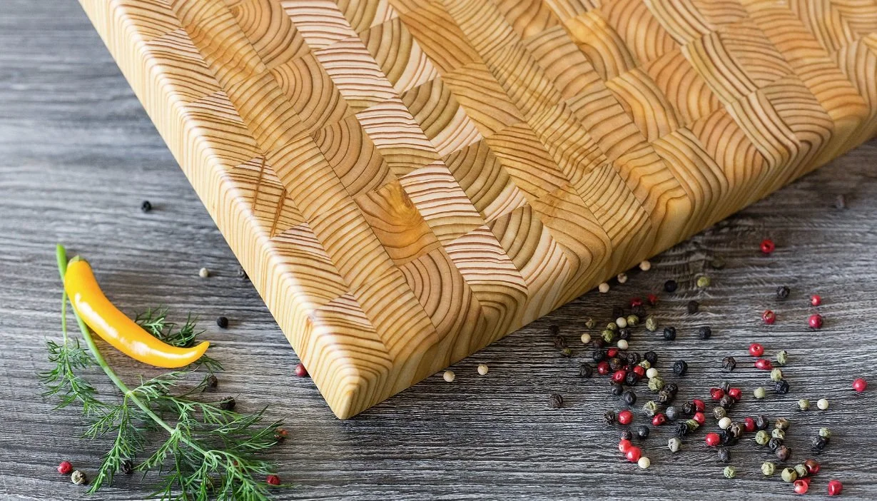 Macro detail of self-healing Canadian Larch wood grain on a professional Larchsmith culinary surface.