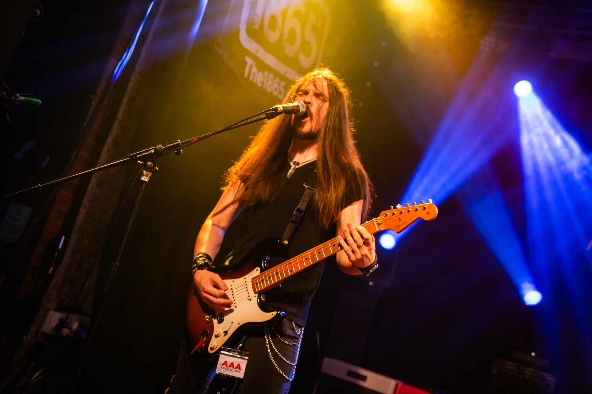 Jack Davies, the guitarist with the punk rock band from Wales 'James Kennedy and The Underdogs' singing and playing guitar on stage during a UK tour 2025
