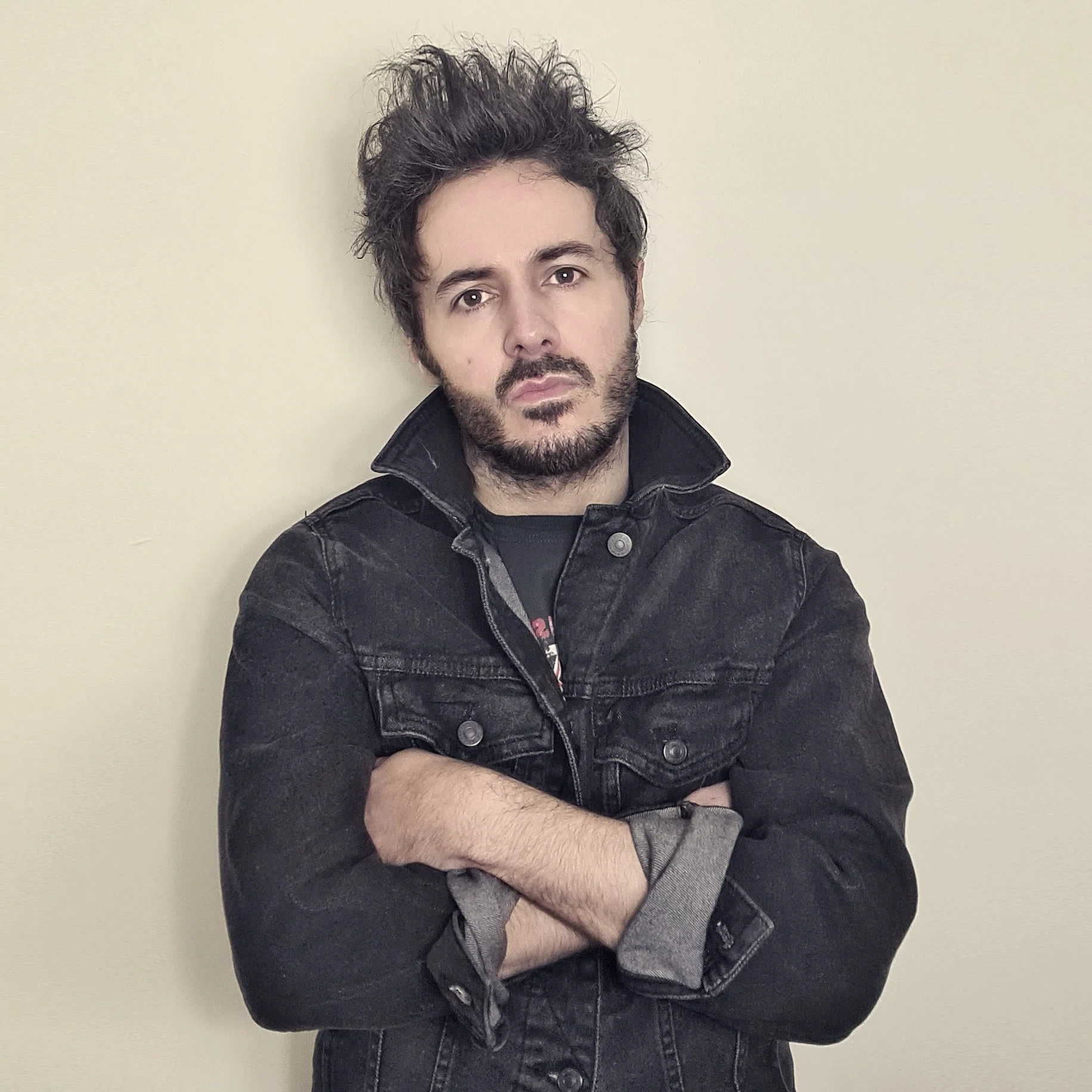 James Kennedy, the singer of the band 'James Kennedy and The Underdogs' posing in a denim jacket and spikey hair