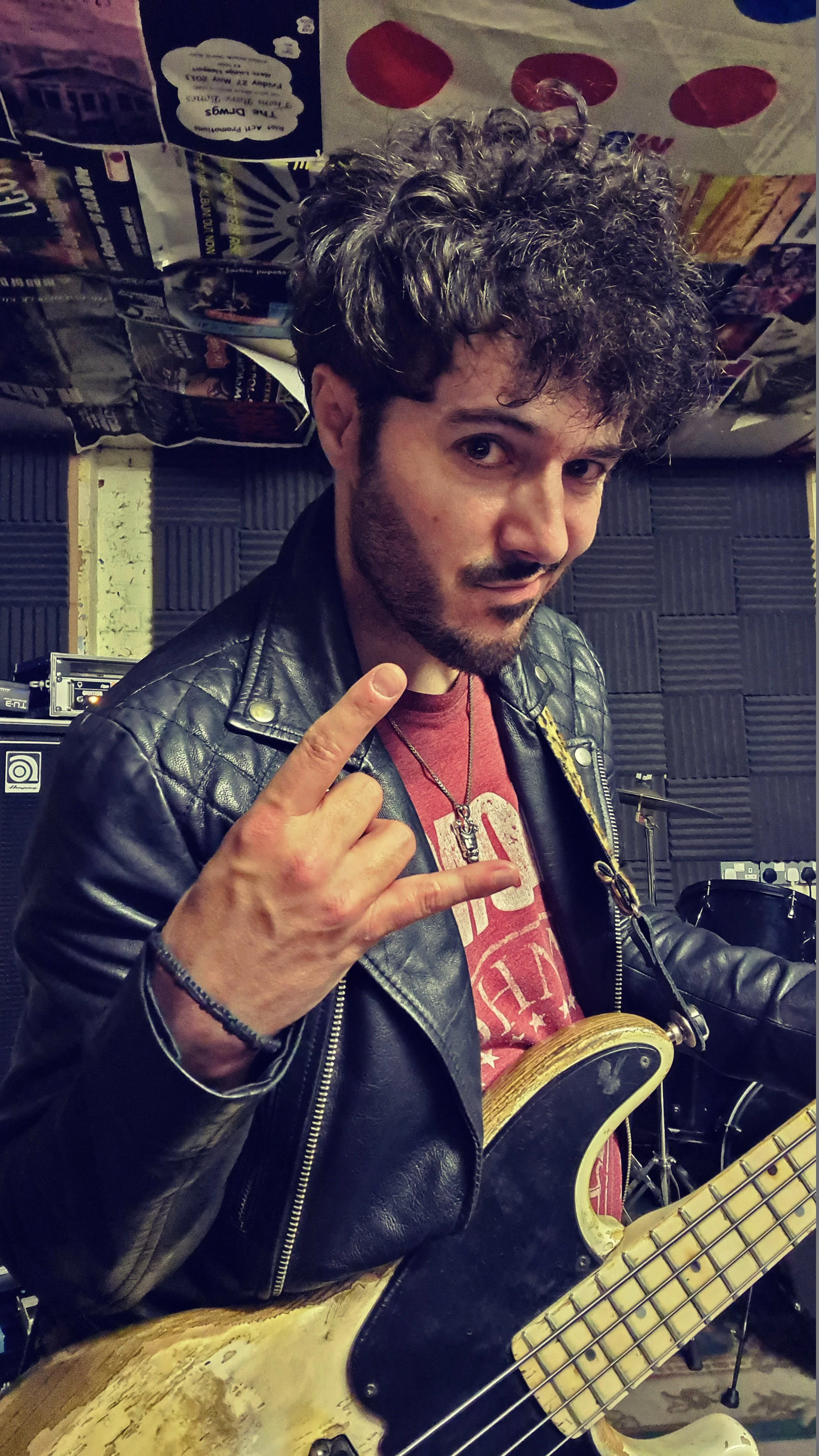 James Kennedy, the singer in the rock band 'James Kennedy and The Underdogs' posing with a bass guitar and messy hair