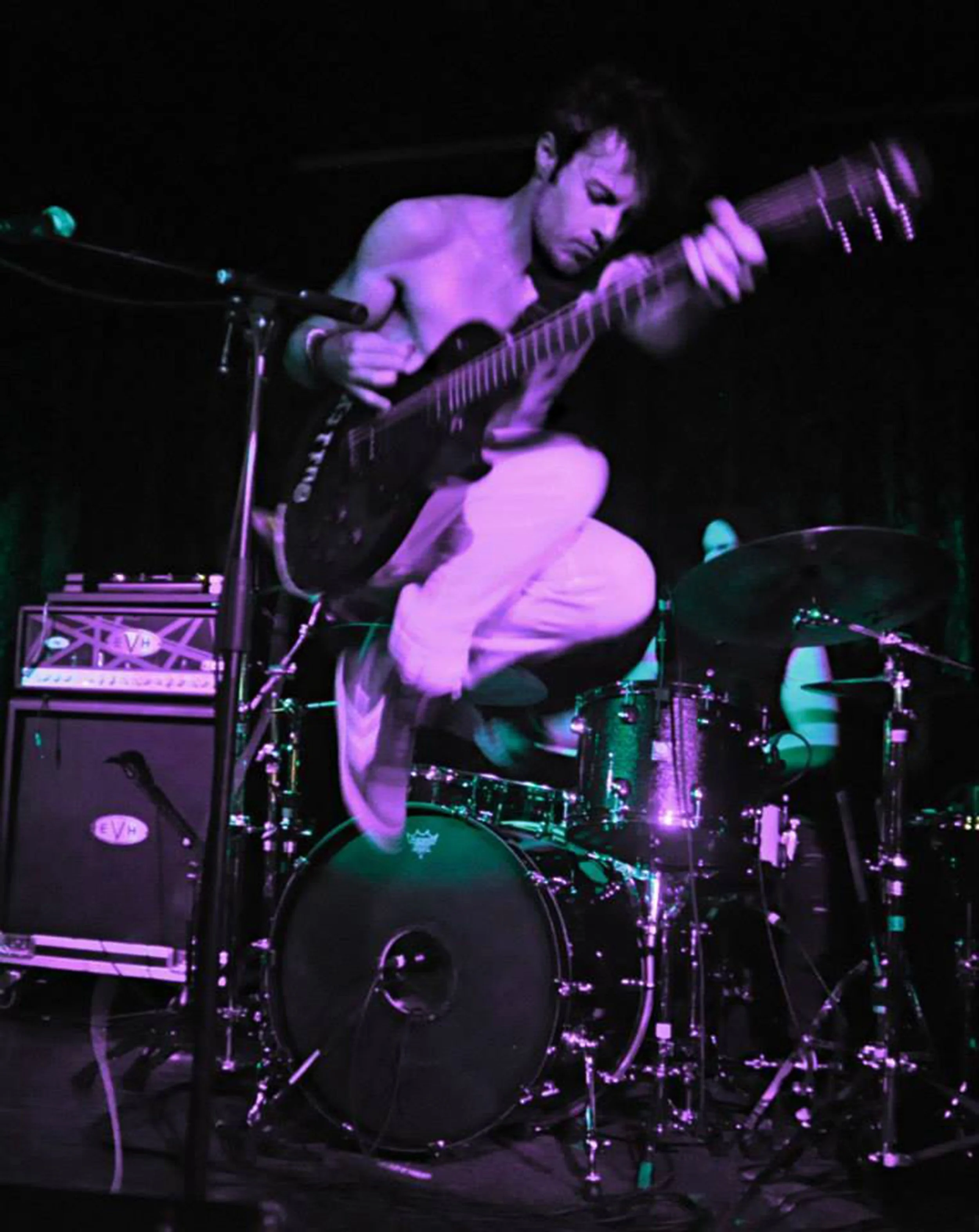 James Kennedy, the singer with the rock band 'Kyshera' jumping in the air during a Kyshera concert in London