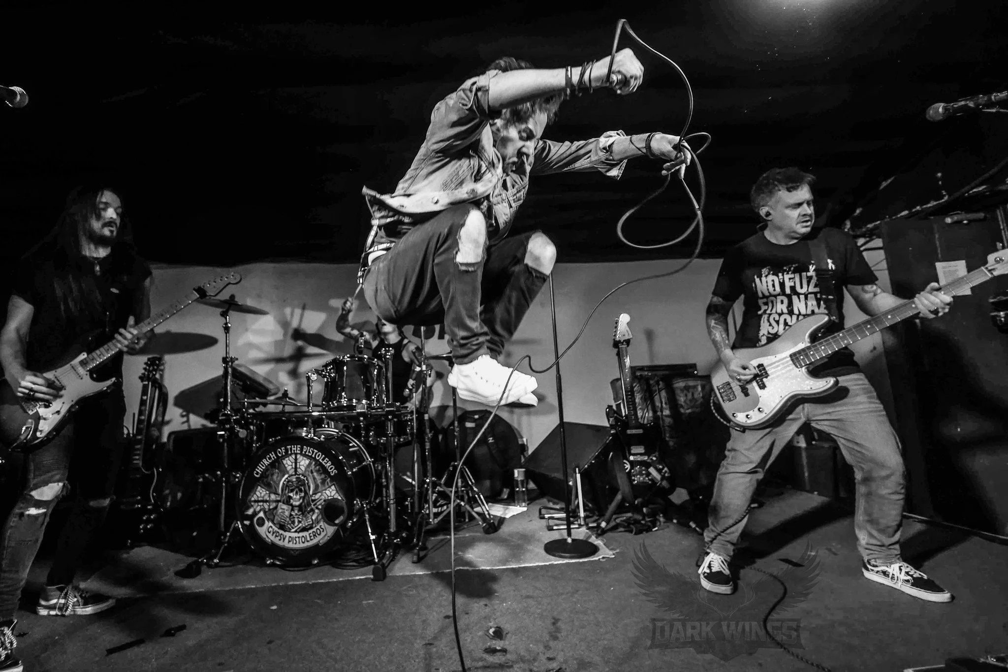 James Kennedy and The Underdogs live on stage with singer, James Kennedy jumping in the air