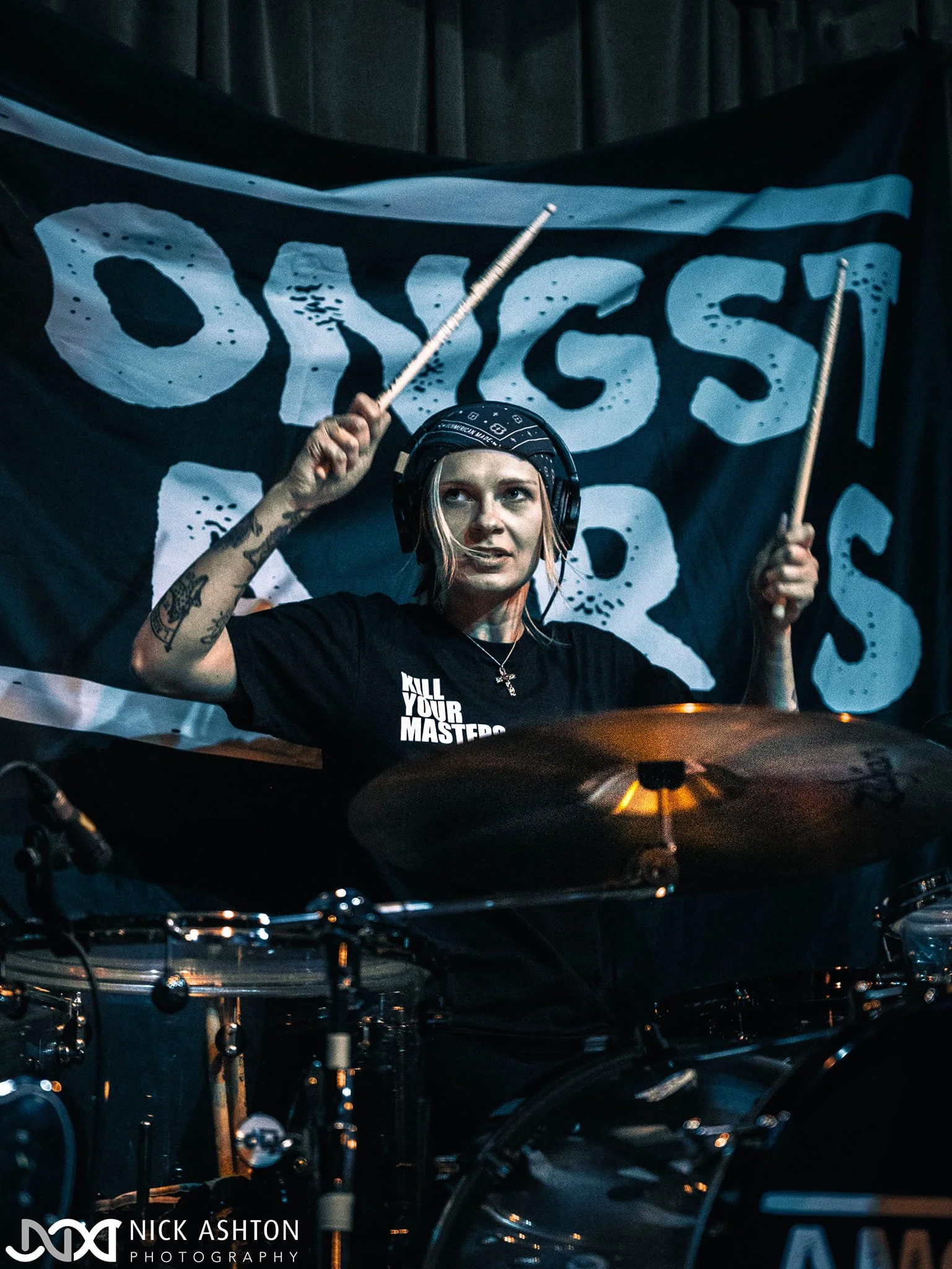 Aggy Nowicka, drummer with rock band 'James Kennedy and The Underdogs' on stage playing drums at a show