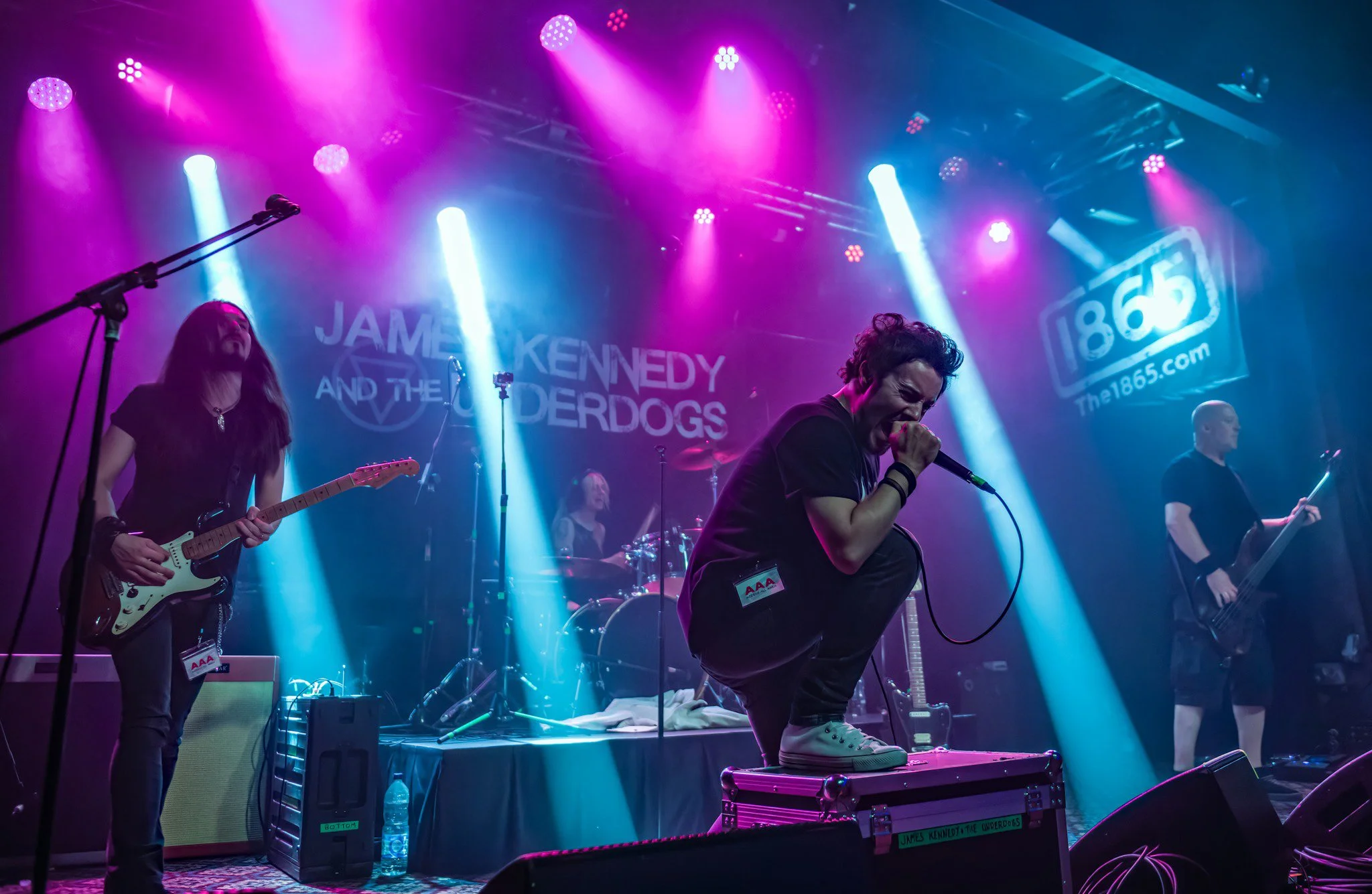 'James Kennedy and The Underdogs', the rock band from Wales, on stage at the 1865 venue in Brighton UK with pink and blue stage lights 