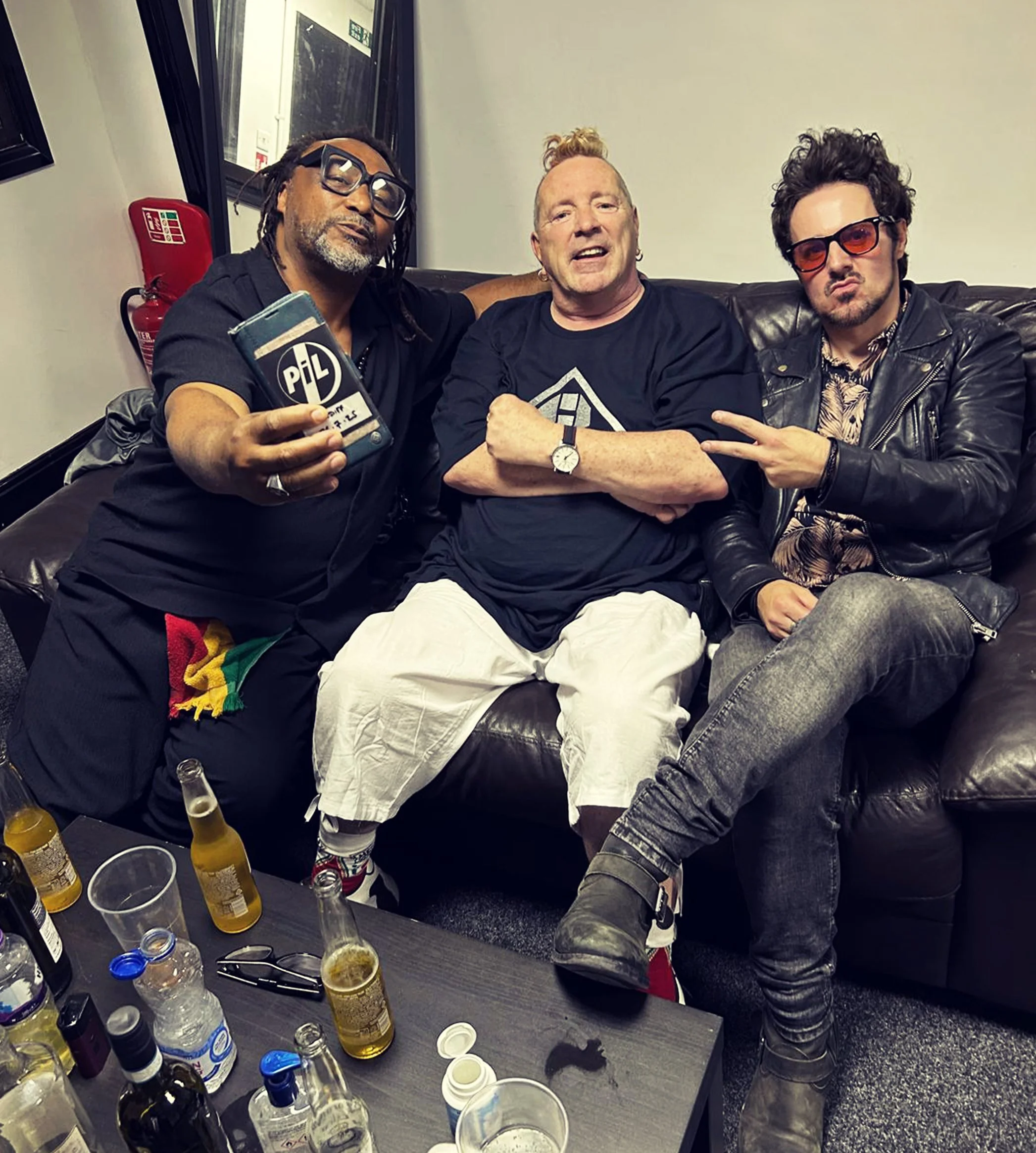 Johnny Rotten, Benji Webbe and singer, James Kennedy posing backstage together