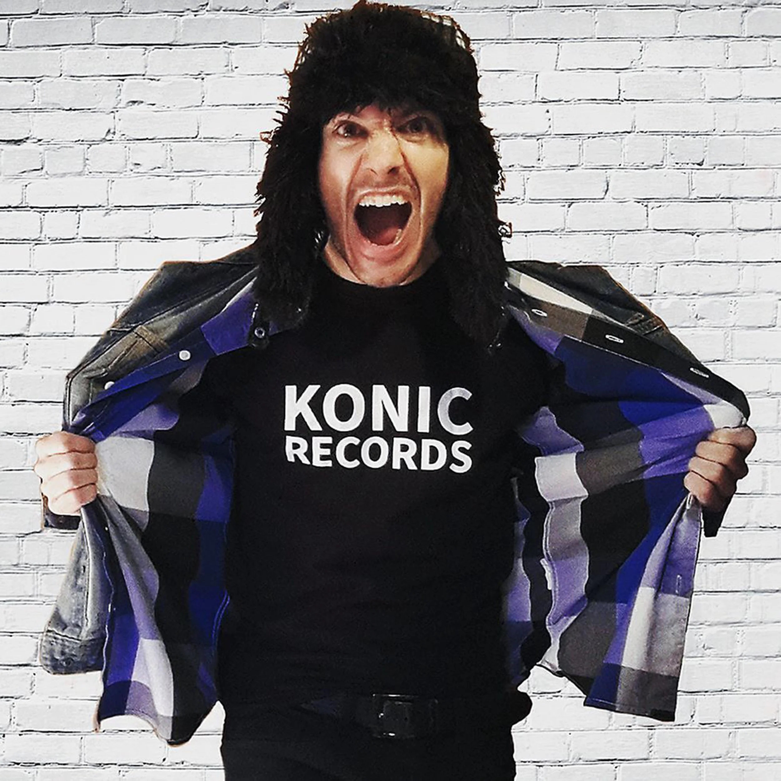 James Kennedy, the rock singer from Wales posing with a Konic Records T-shirt on and wearing a Russian hat 