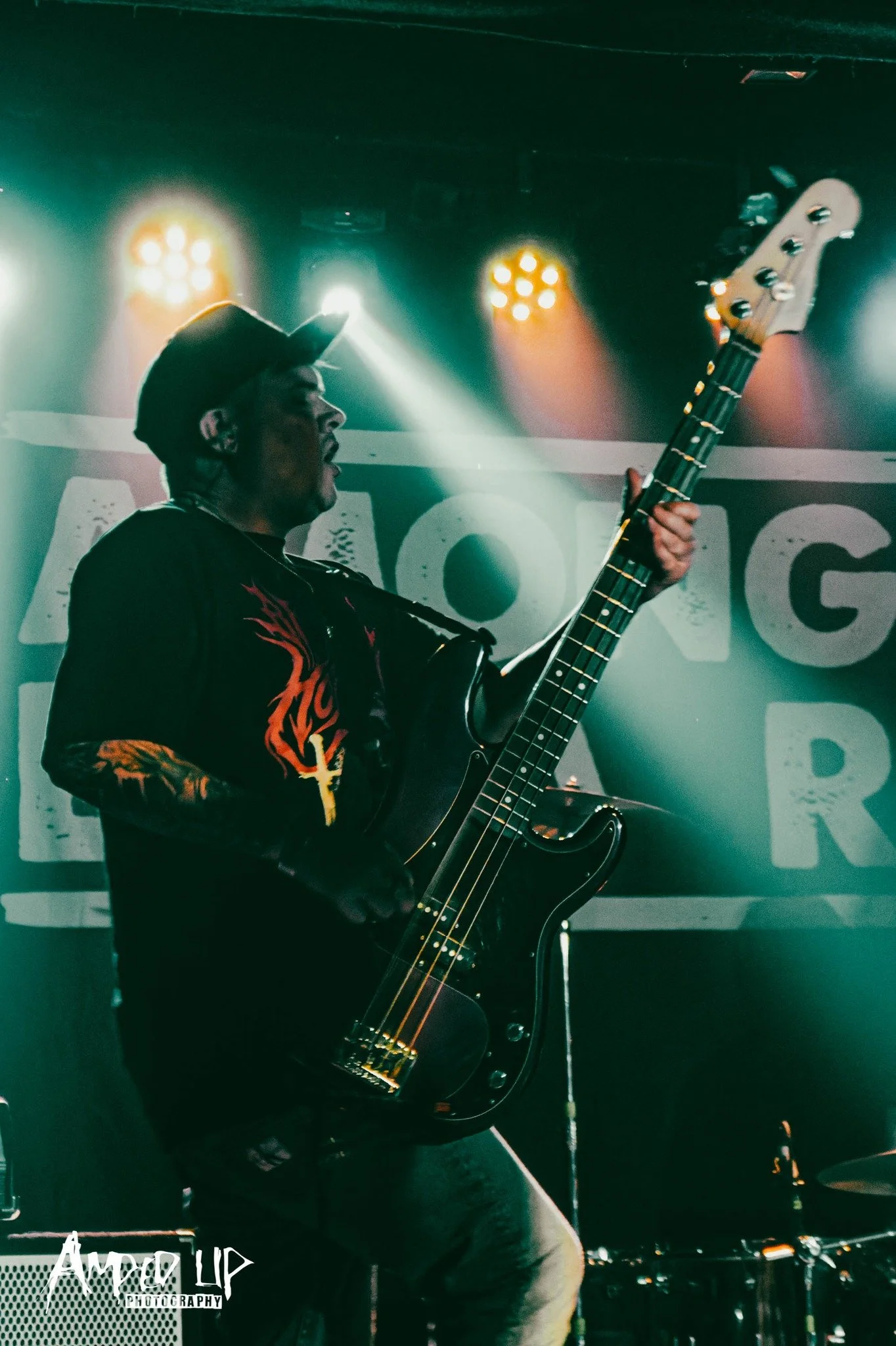 Elliot Blake, bassist with the rock band 'James Kennedy and The Underdogs' on stage on tour under blue stage lights