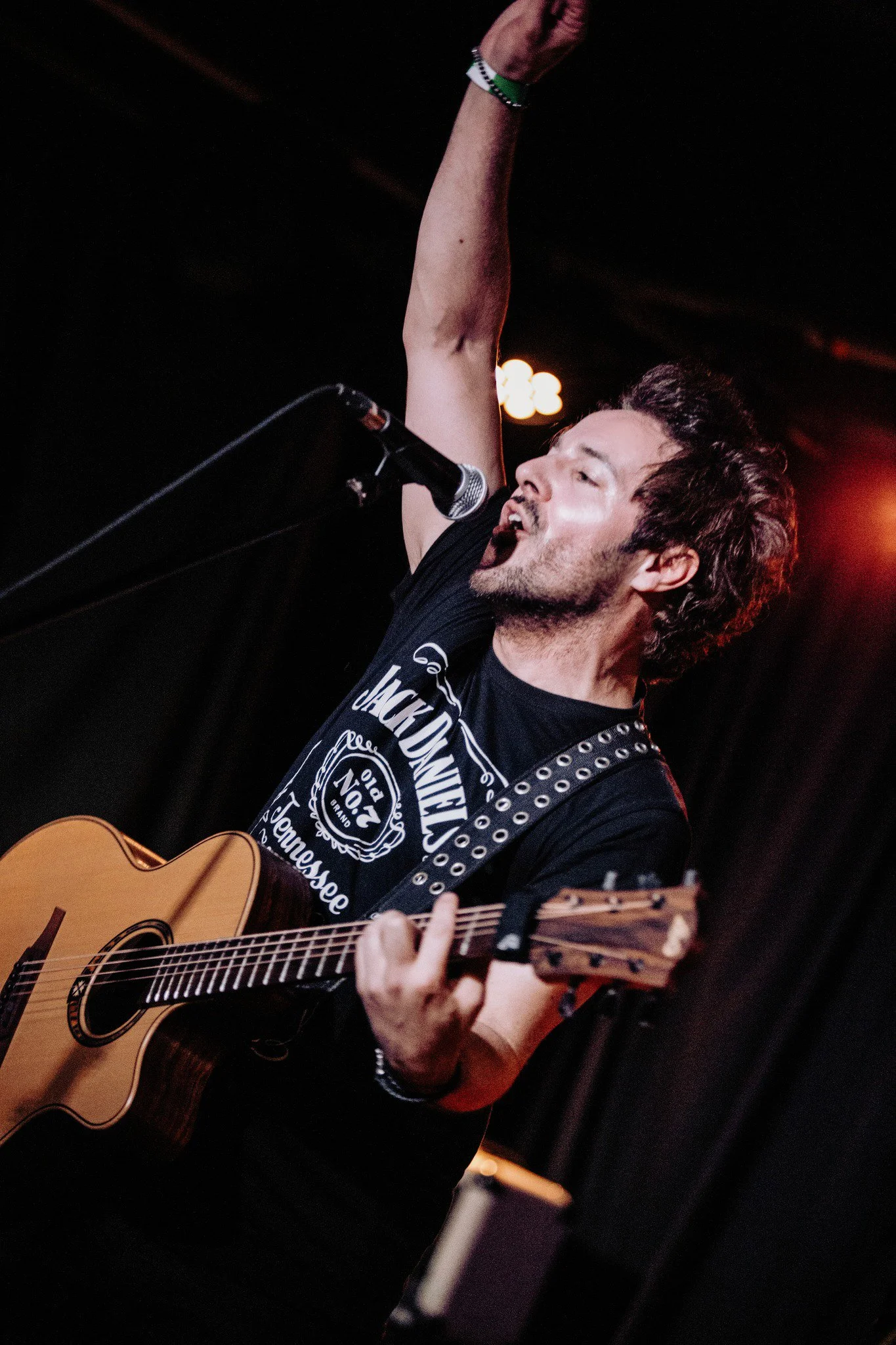 James Kennedy, the singer, musician and author playing an acoustic guitar at a concert with 'James Kennedy and The Underdogs' 
