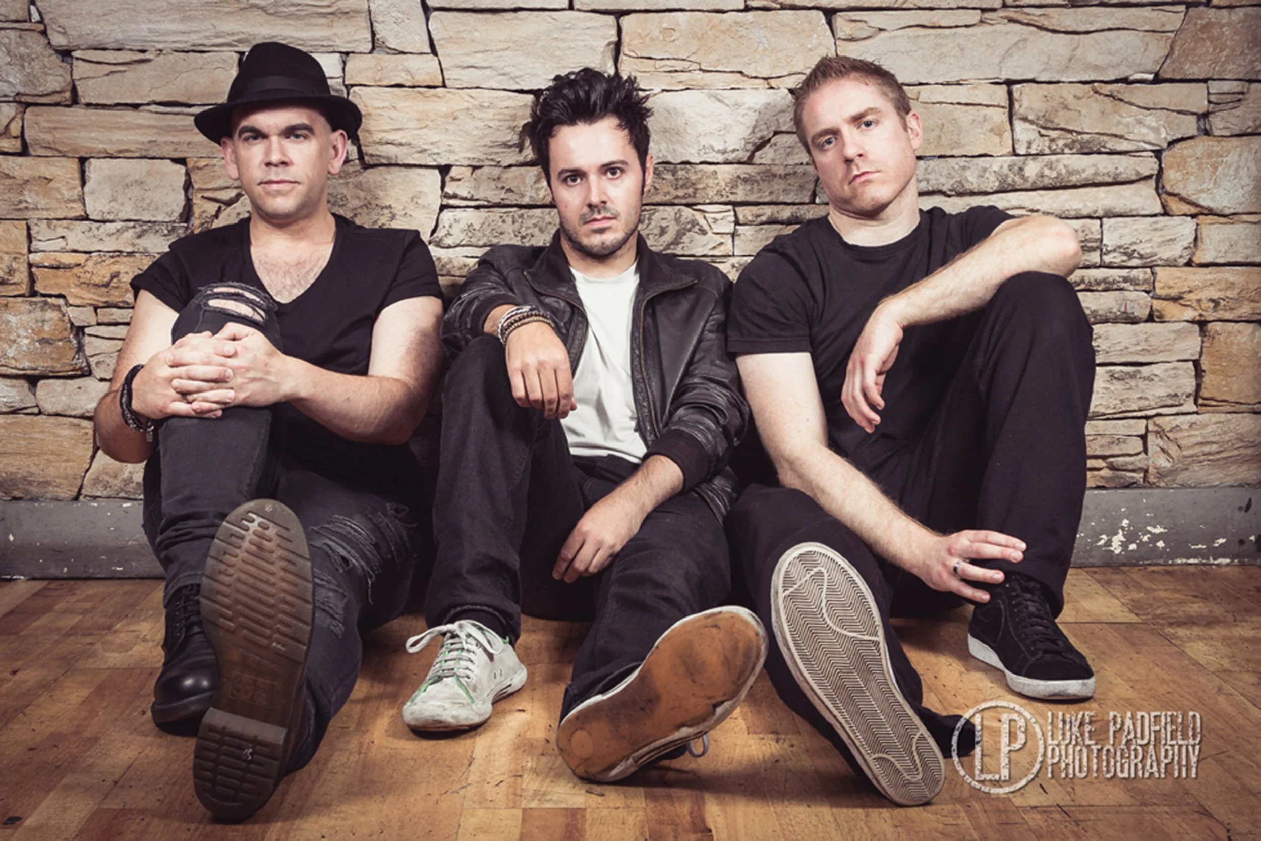 Kyshera, the alternative rock band from South Wales UK sat on the floor for a band photoshoot