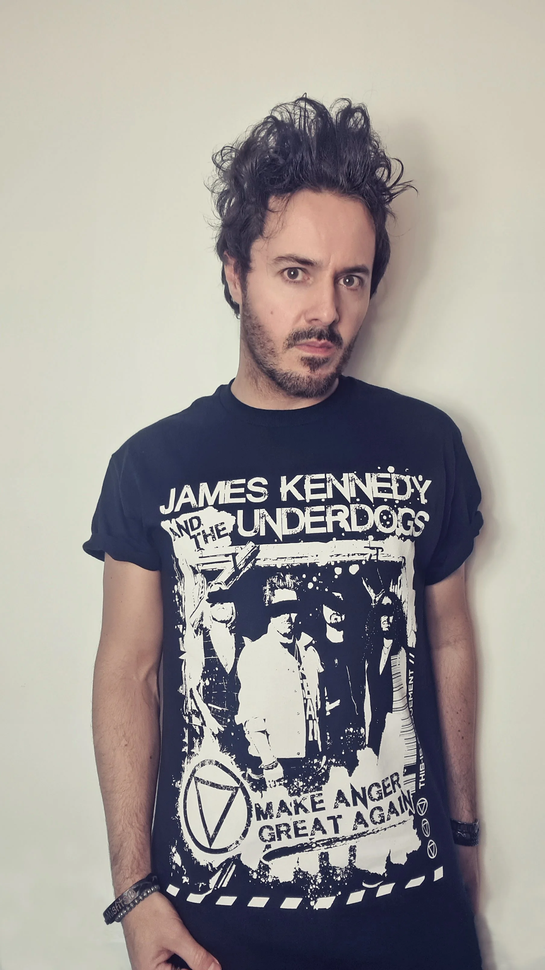 James Kennedy, the singer in the rock band 'James Kennedy and The Underdogs' posing with a band t-shirt 